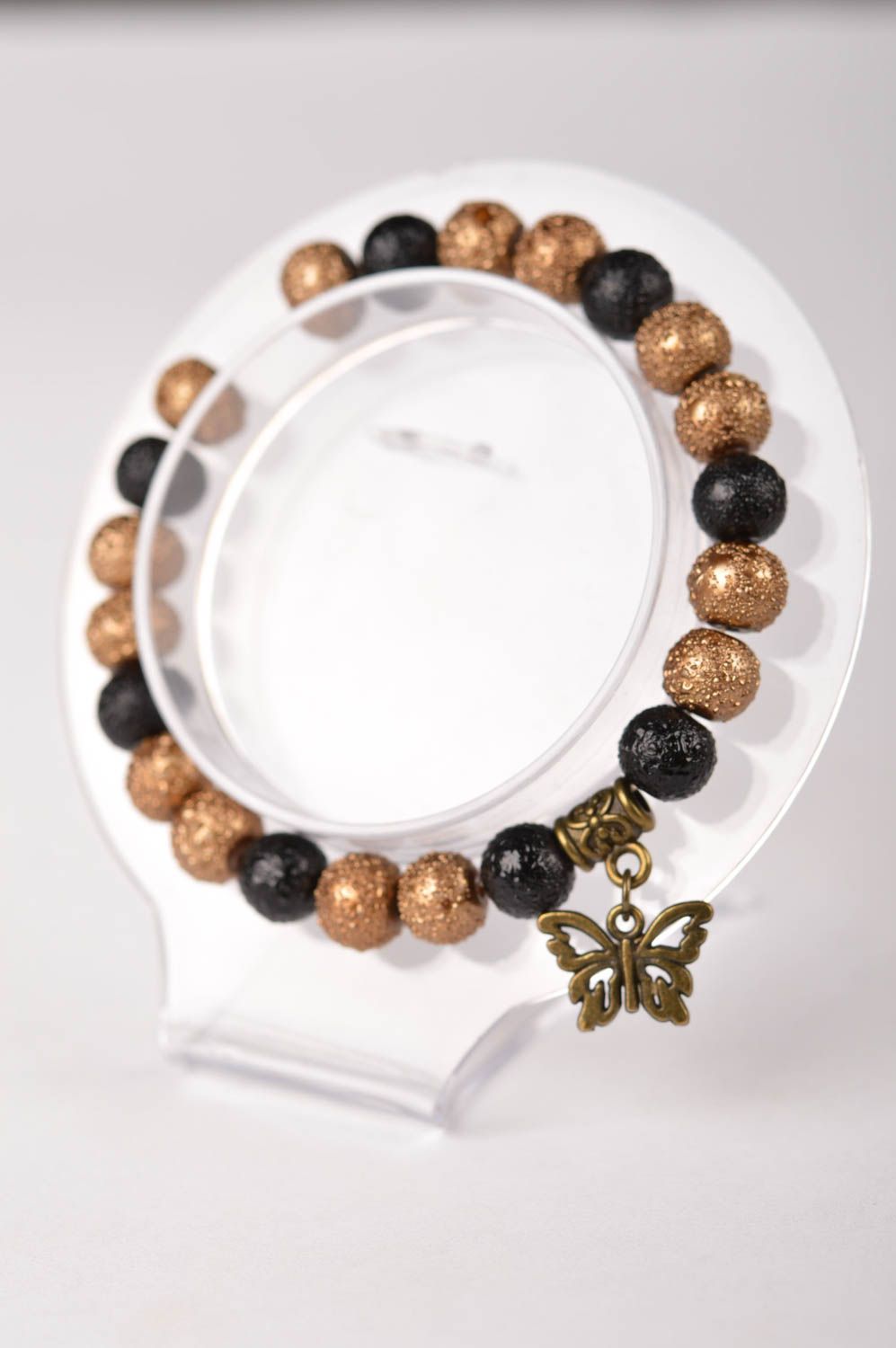 Elastic handmade black and gold color beads bracelet with butterfly charm photo 5