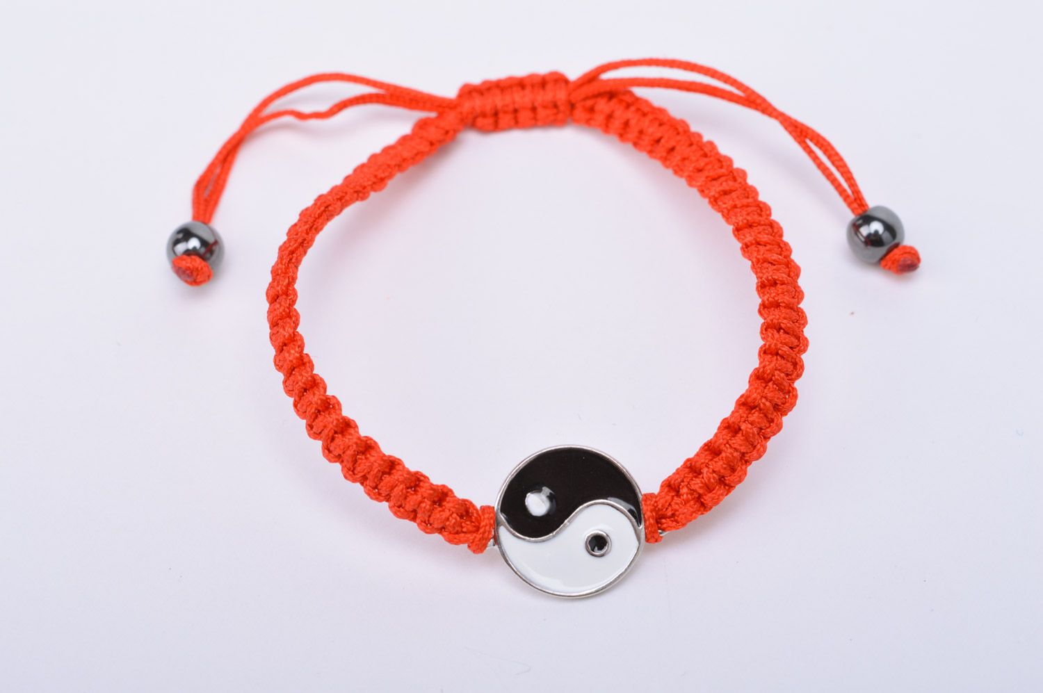 Handmade thin friendship bracelet woven of red threads with Yin and Yang sign photo 2