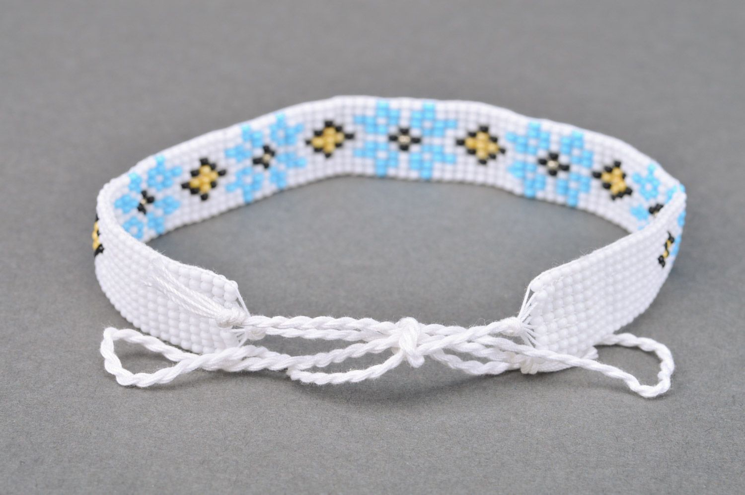 Beautiful women's handmade woven Czech bead necklace of white color with blue flowers photo 5