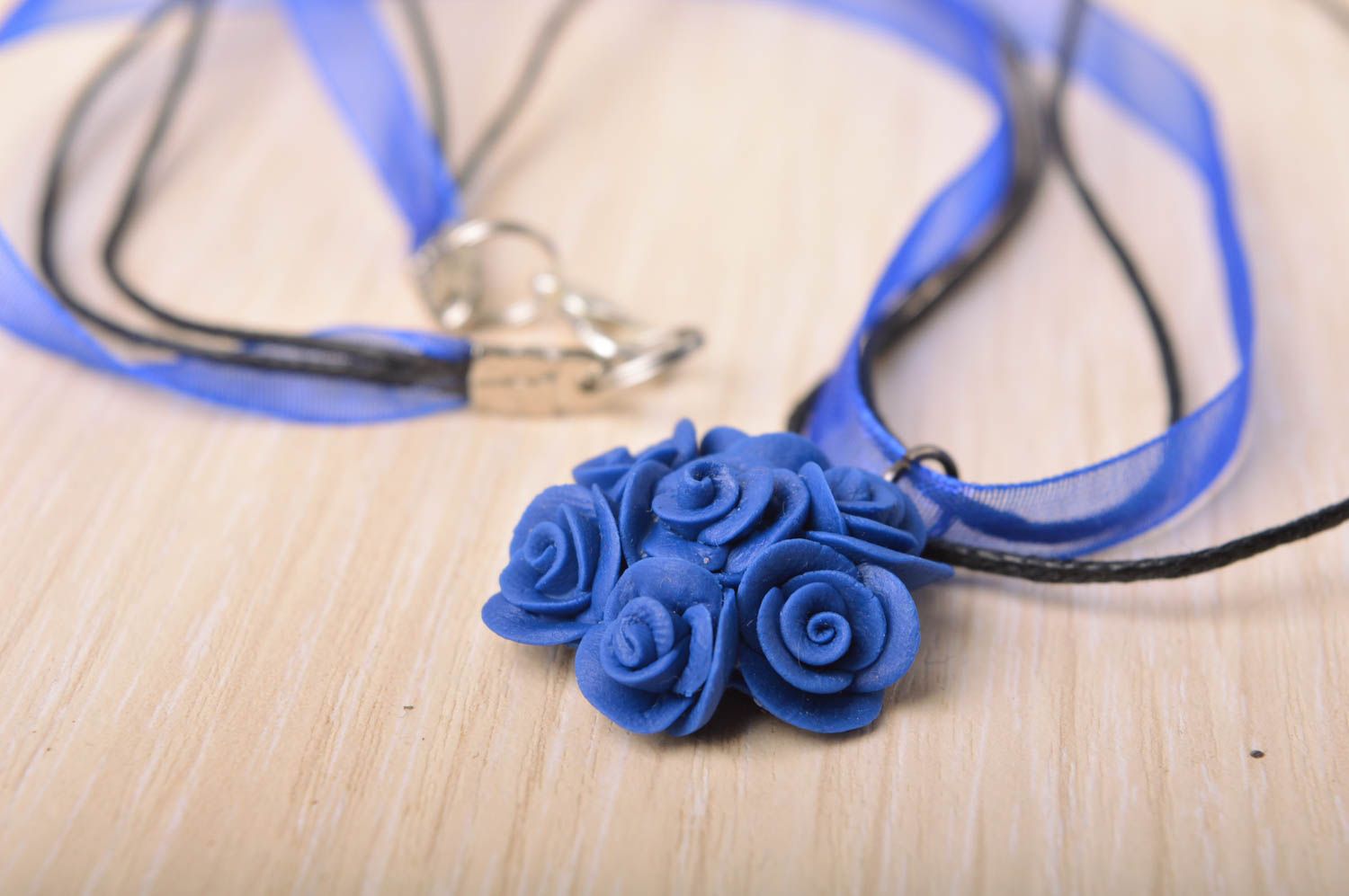 Handmade small floral deep blue cold porcelain pendant on ribbon and cord photo 1