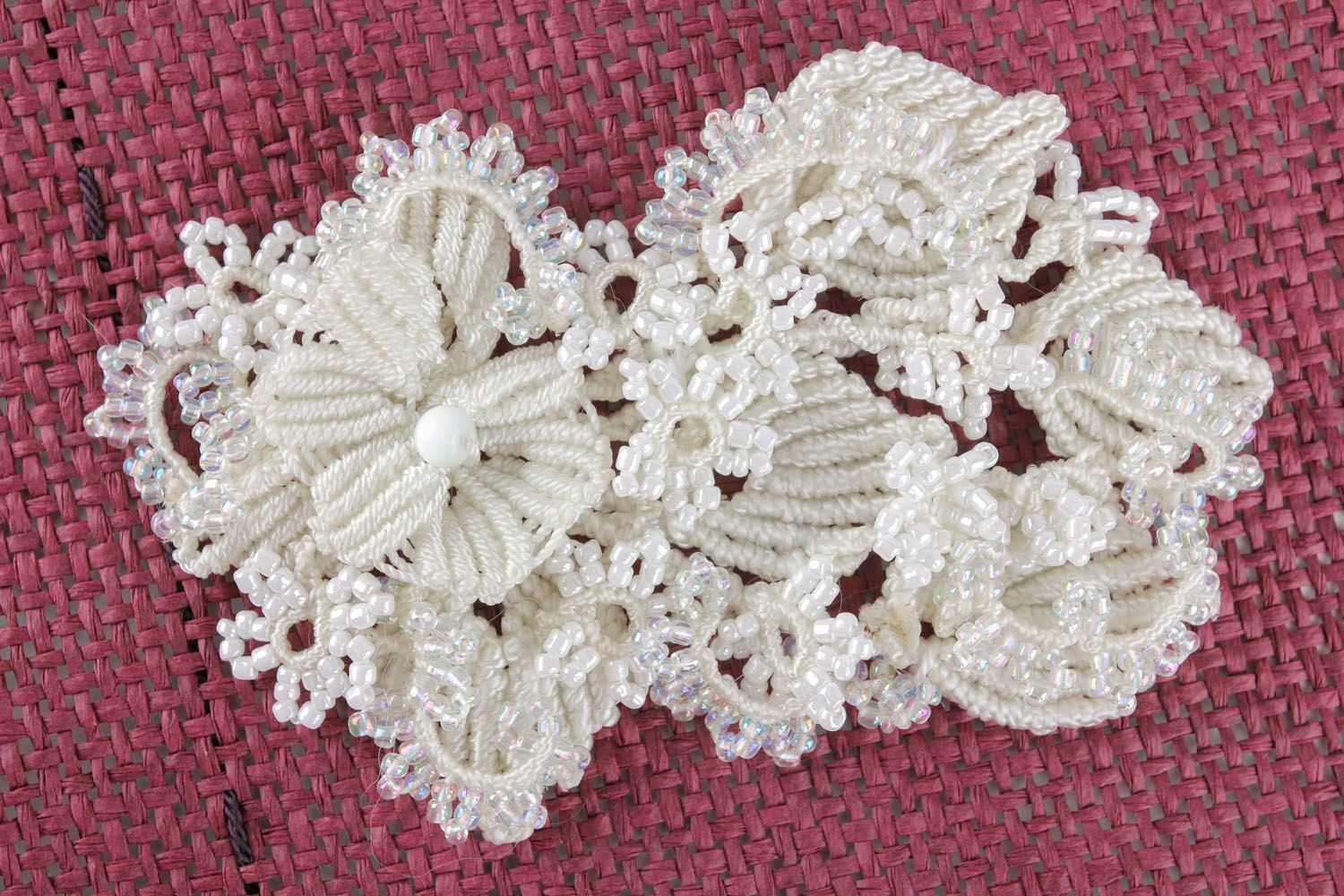 White brooch made of threads and beads photo 1