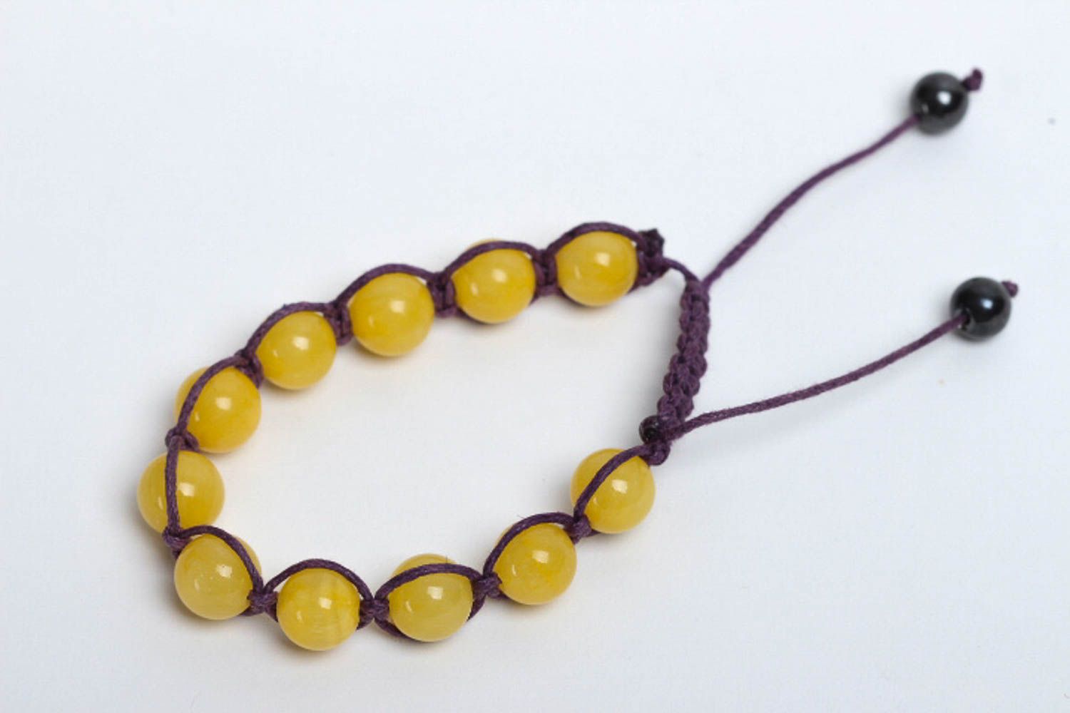 Yellow hematite and calcite beads strand bracelet on black cord  photo 2