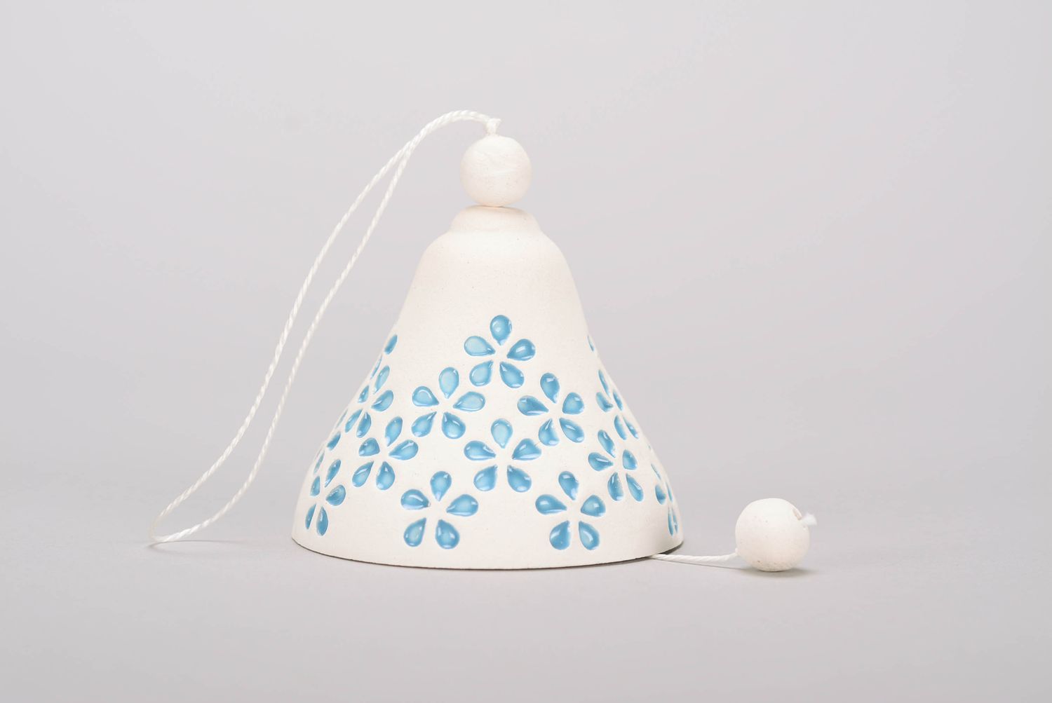 Handmade bell made from white clay with embossment photo 1