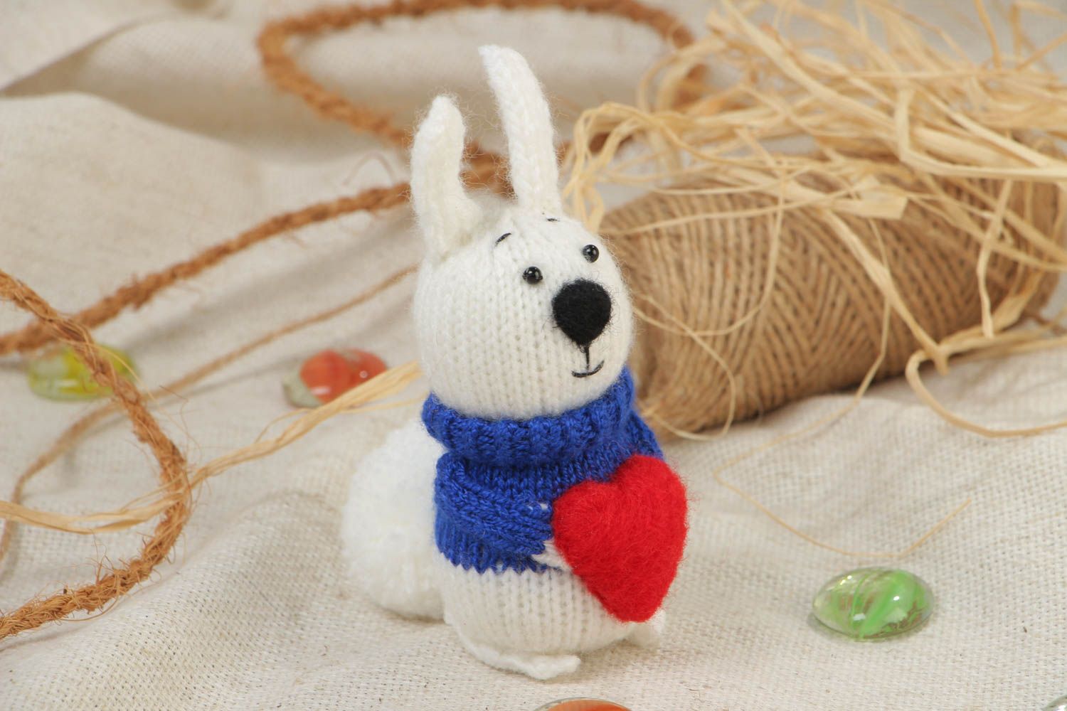 Handmade soft knitted white rabbit toy with a red heart for children photo 1