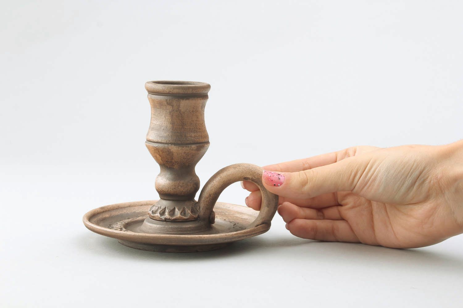 Candlestick made of red clay photo 2