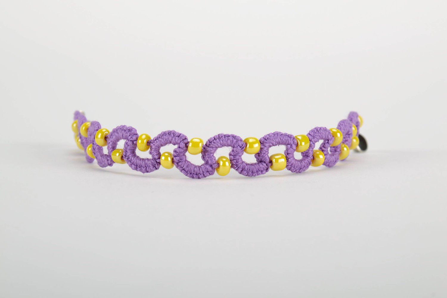 Purple bracelet woven from threads photo 2
