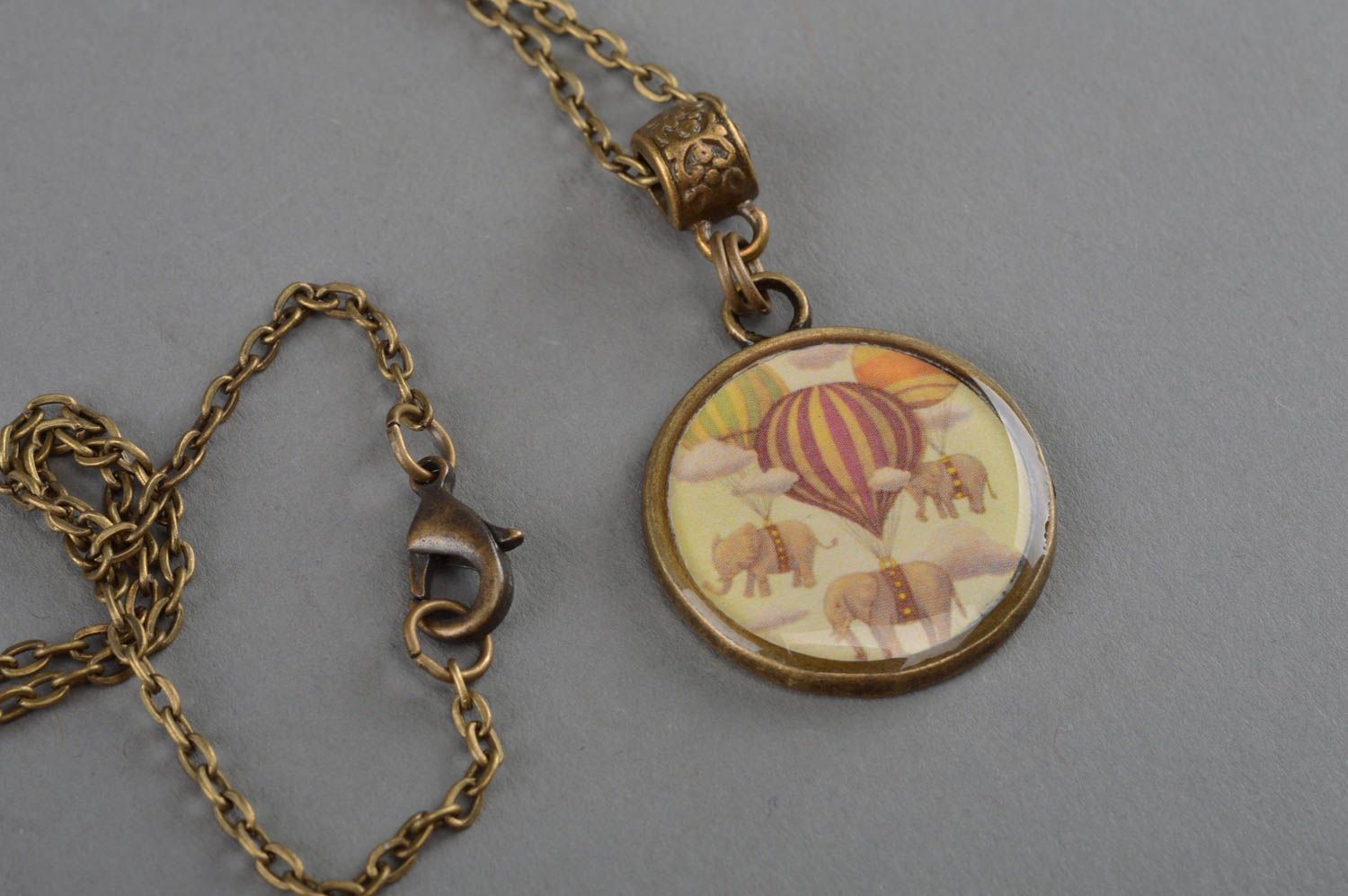 Beautiful handmade decoupage pendant coated with epoxy and equipped with bronze-like chain photo 2