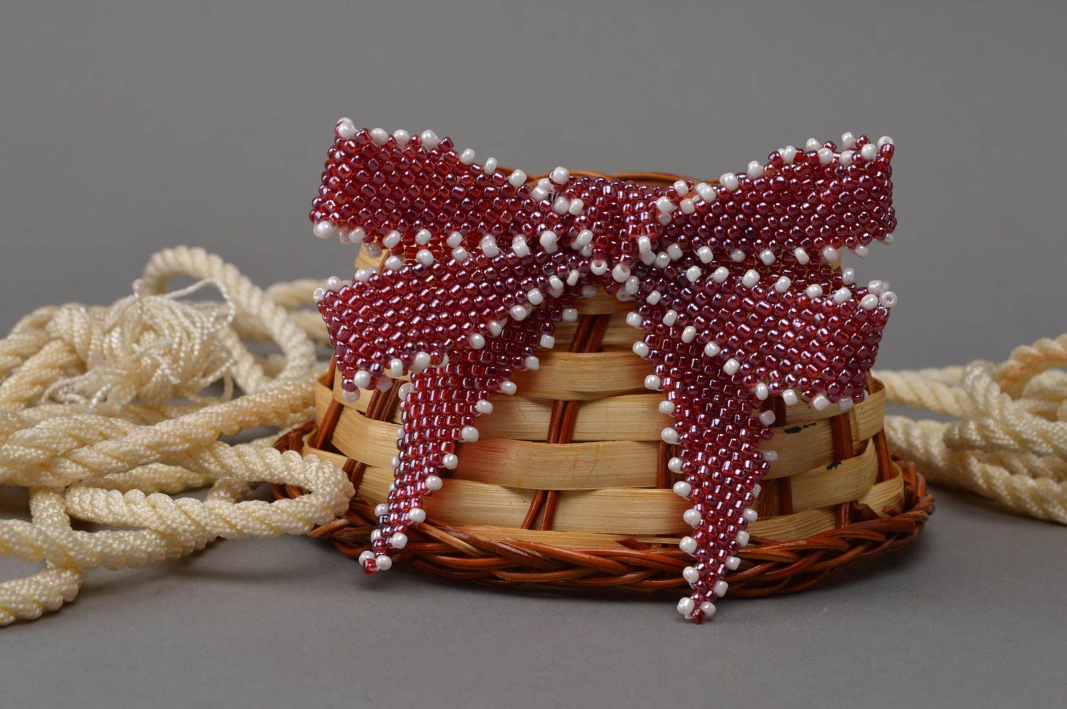 Small handmade brooch in the form of a bow made in red color with white accents photo 1