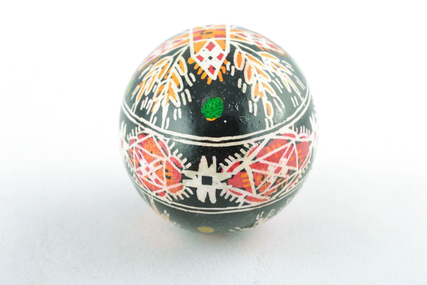 Handmade Easter egg with rich ornament on black background painted with hot wax  photo 3