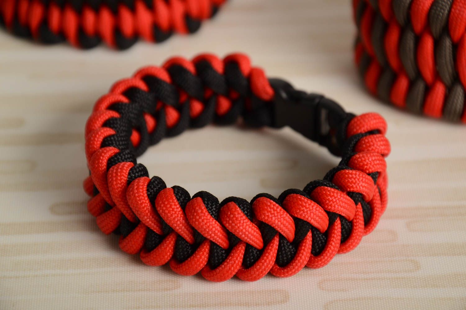 Red and black handmade wrist bracelet woven of American paracord photo 1