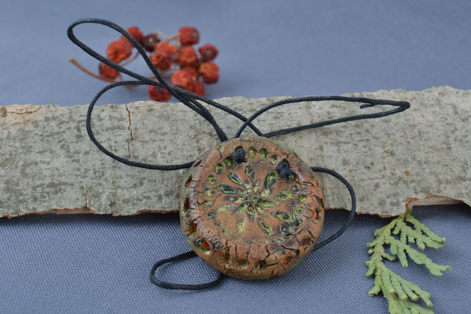 Handmade volume ceramic pendant of round shape with ornament painted with acrylics photo 1