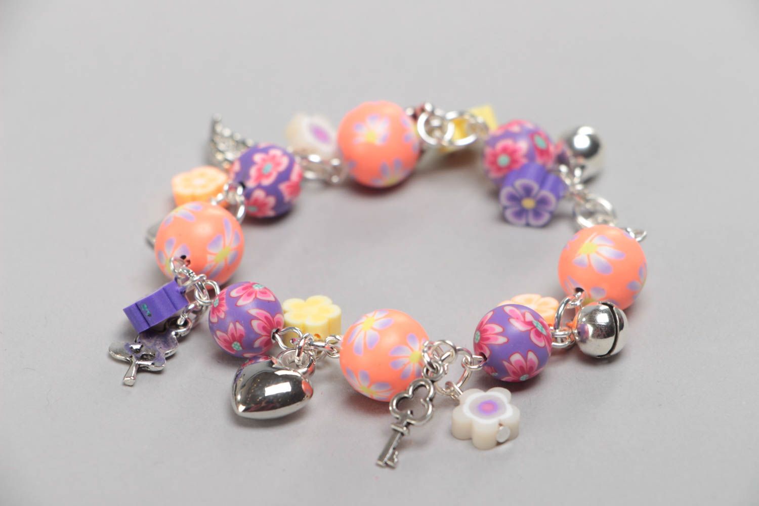 Unusual colorful handmade children's plastic wrist bracelet with charms photo 2
