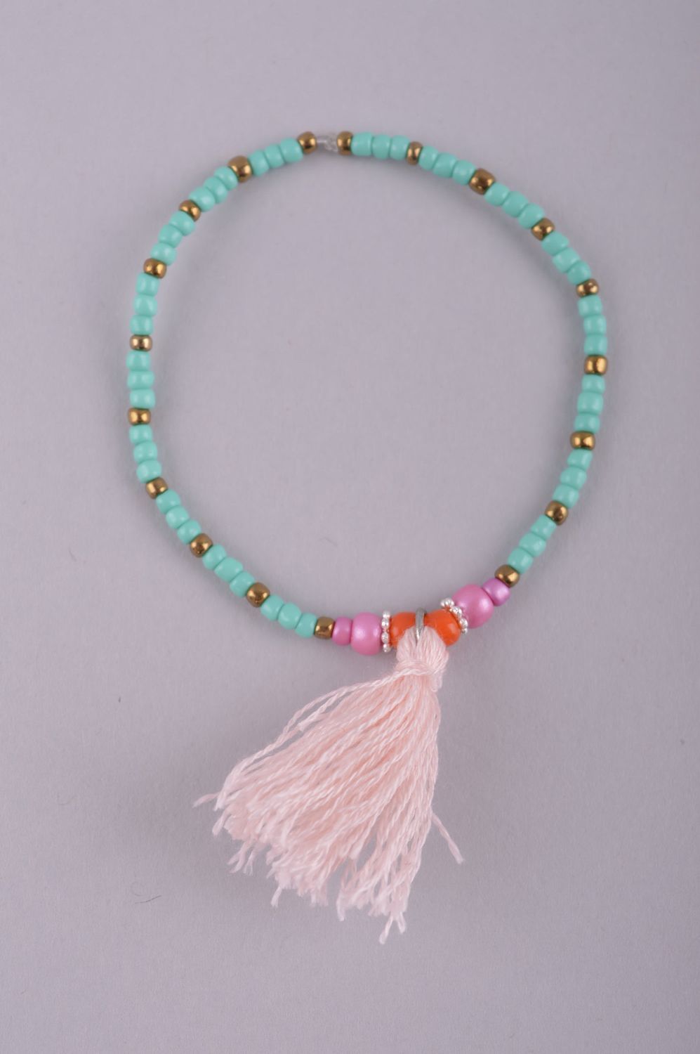 Stretch turquoise and pink handmade bracelet with a pink charm for girls photo 2