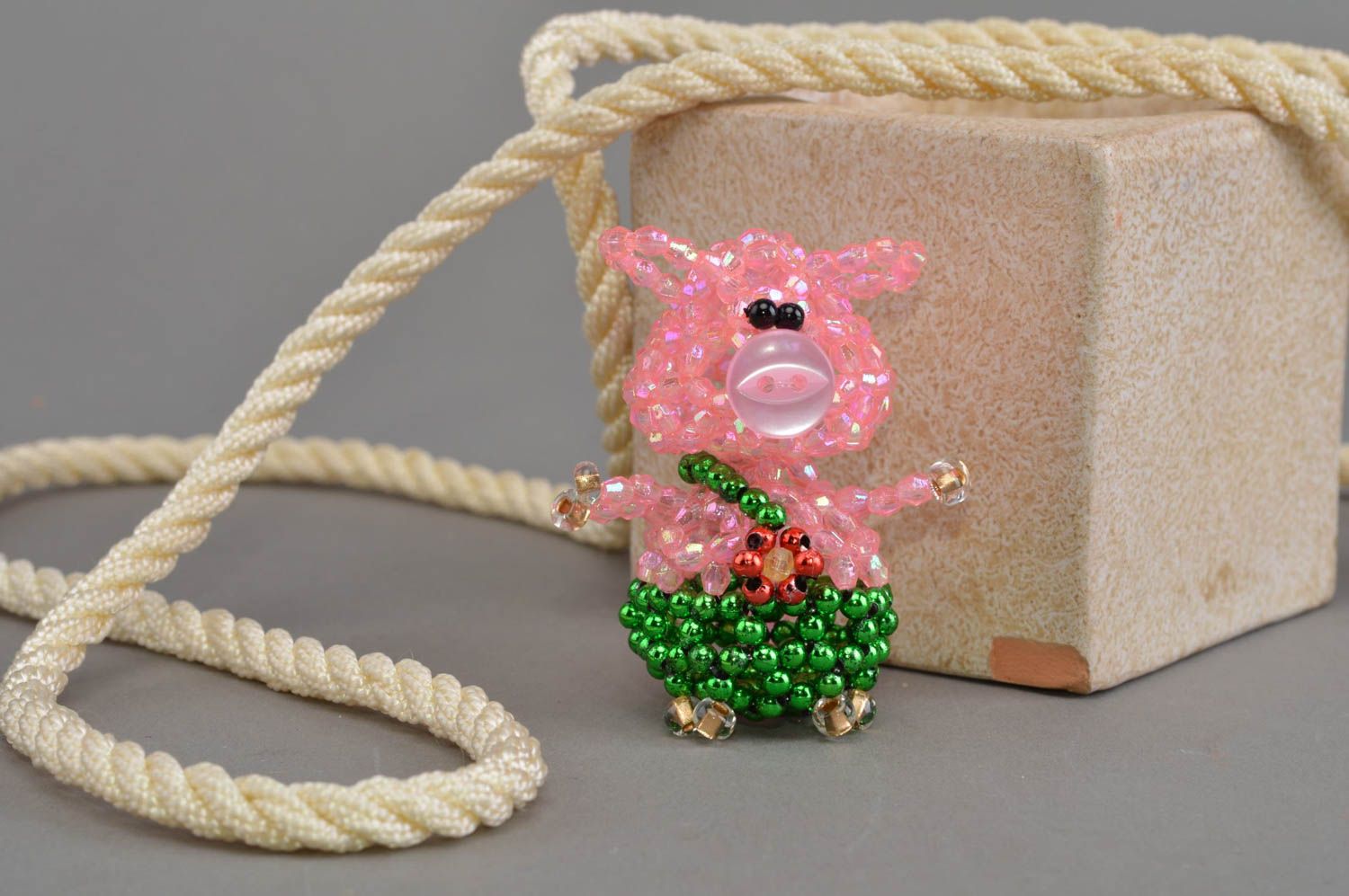 Small handmade designer pink beaded figurine of pig in green pants home decor photo 1
