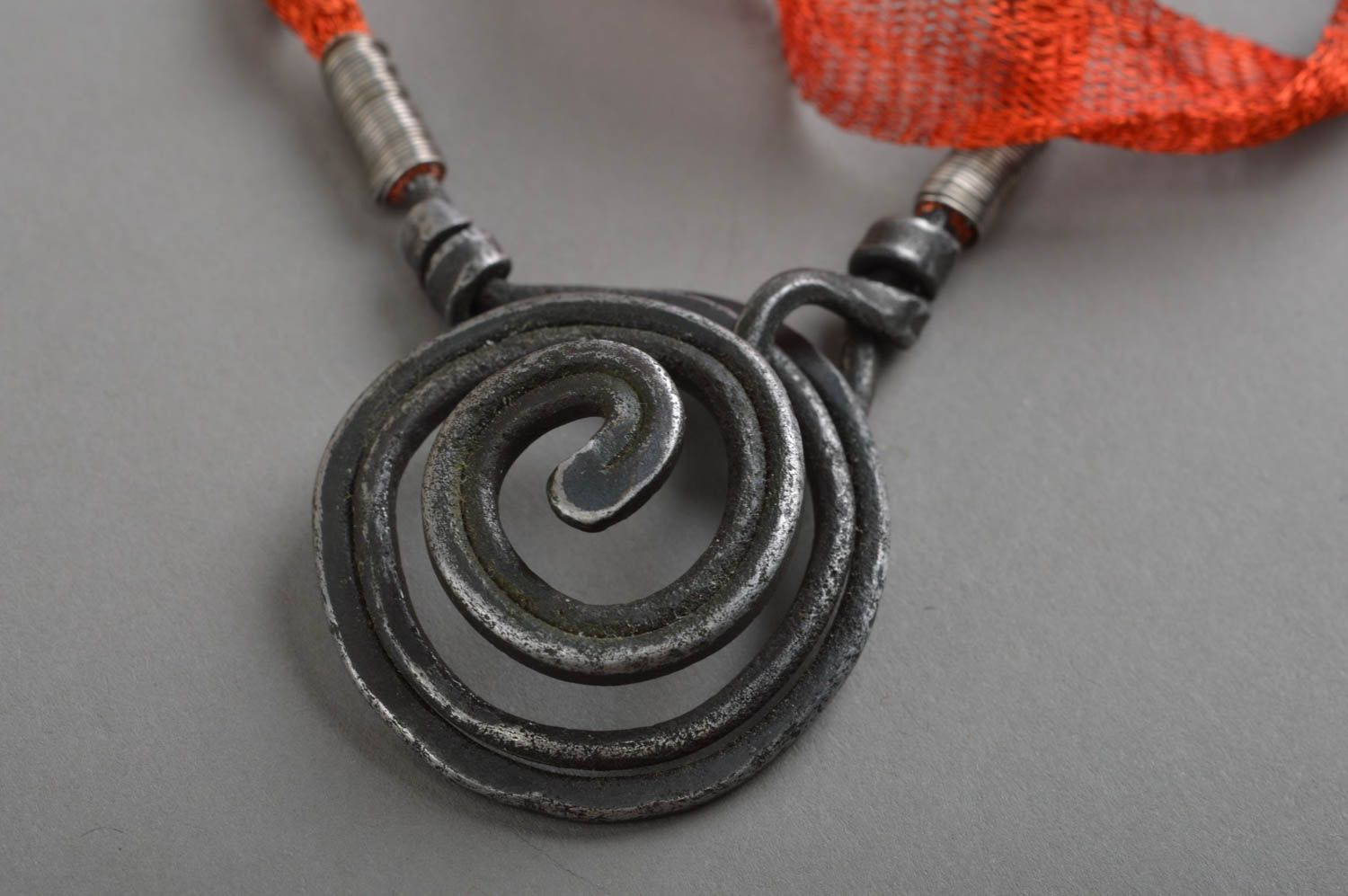 Necklace on red lace with manually forged pendant made of iron Whirl anthracite photo 3