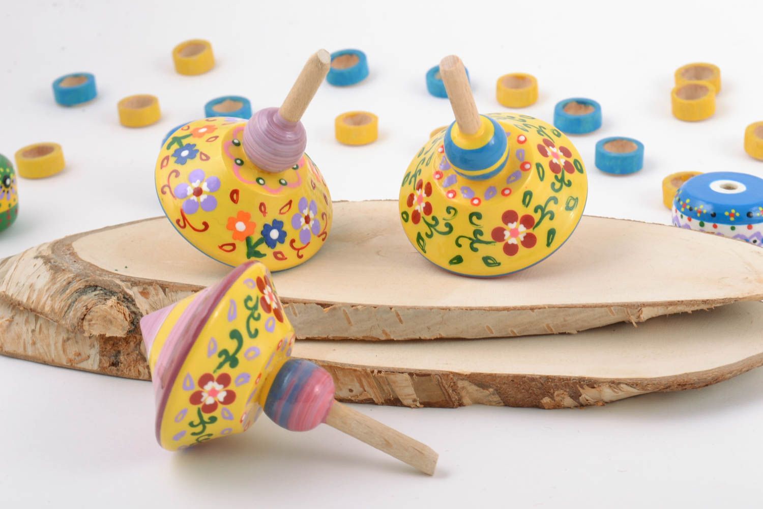 Set of handmade yellow painted wooden toys eco spinning tops 3 pieces photo 1