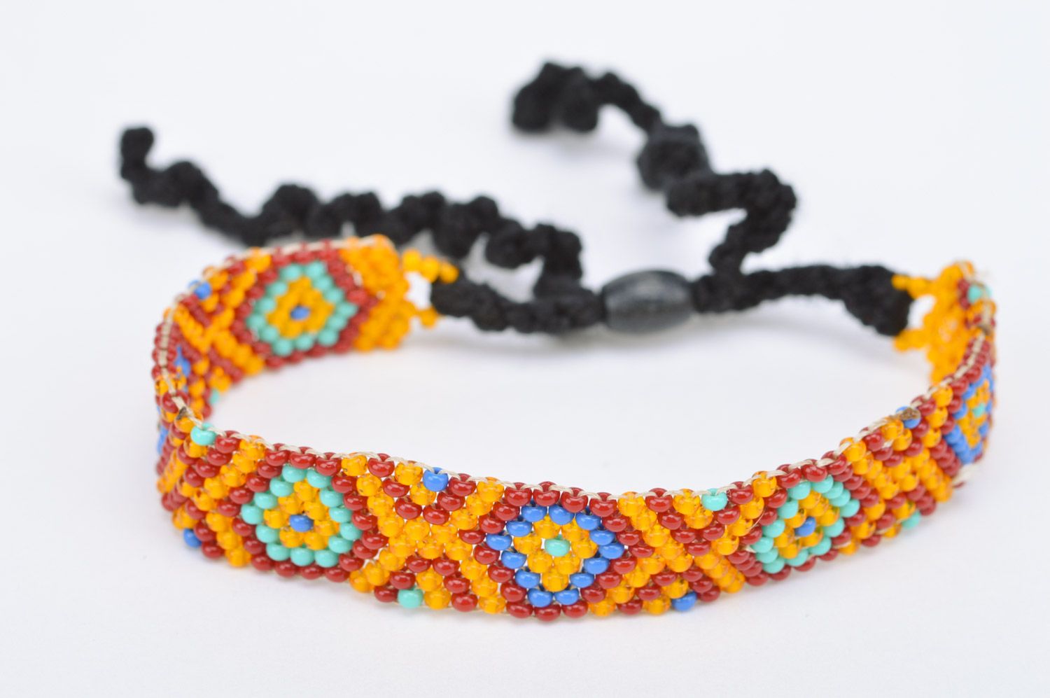 Handmade orange wrist bracelet woven of Czech beads with geometric ornament photo 2