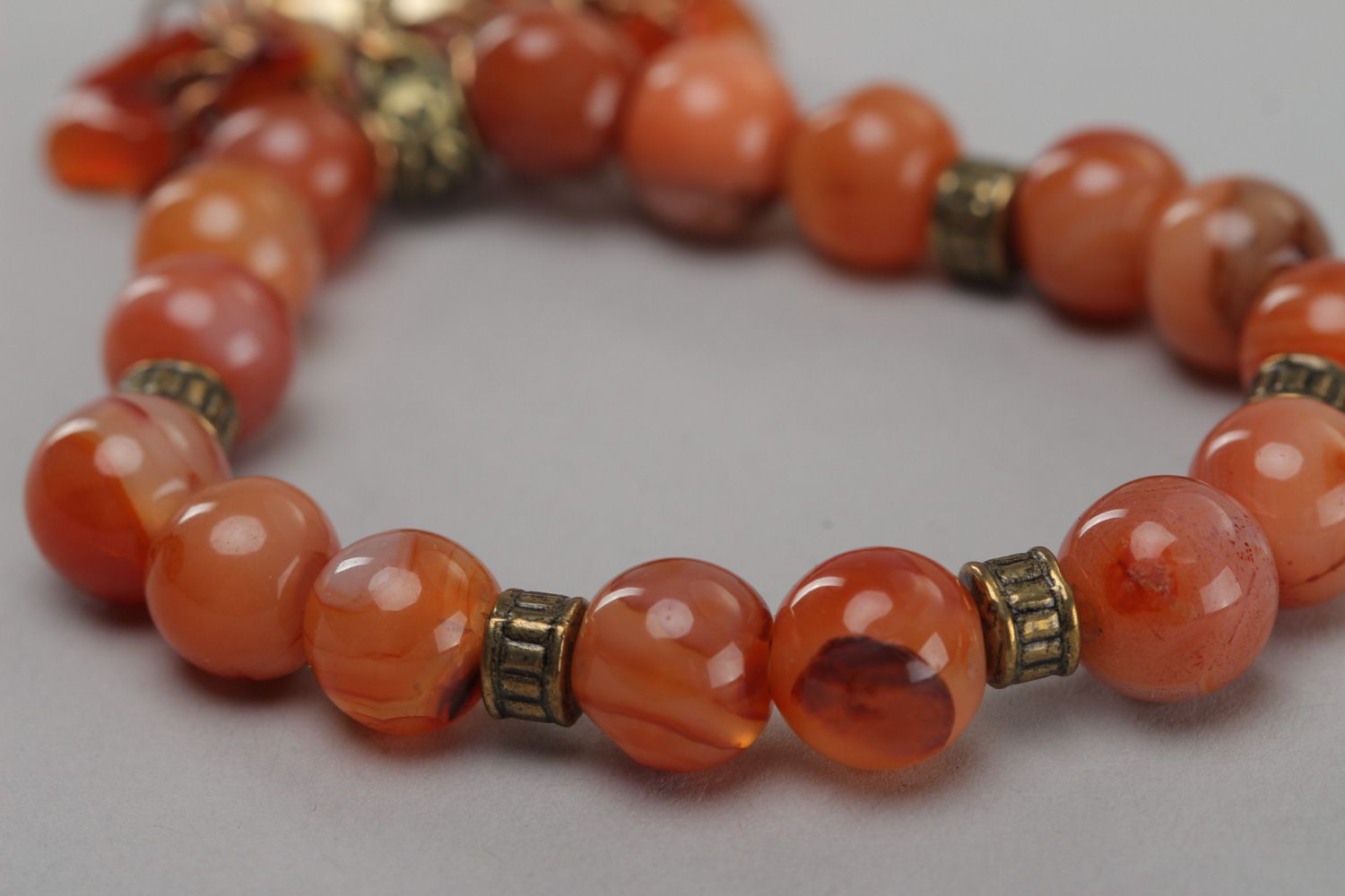 Handmade stretch wrist bracelet with natural cornelian beads of brown color photo 4