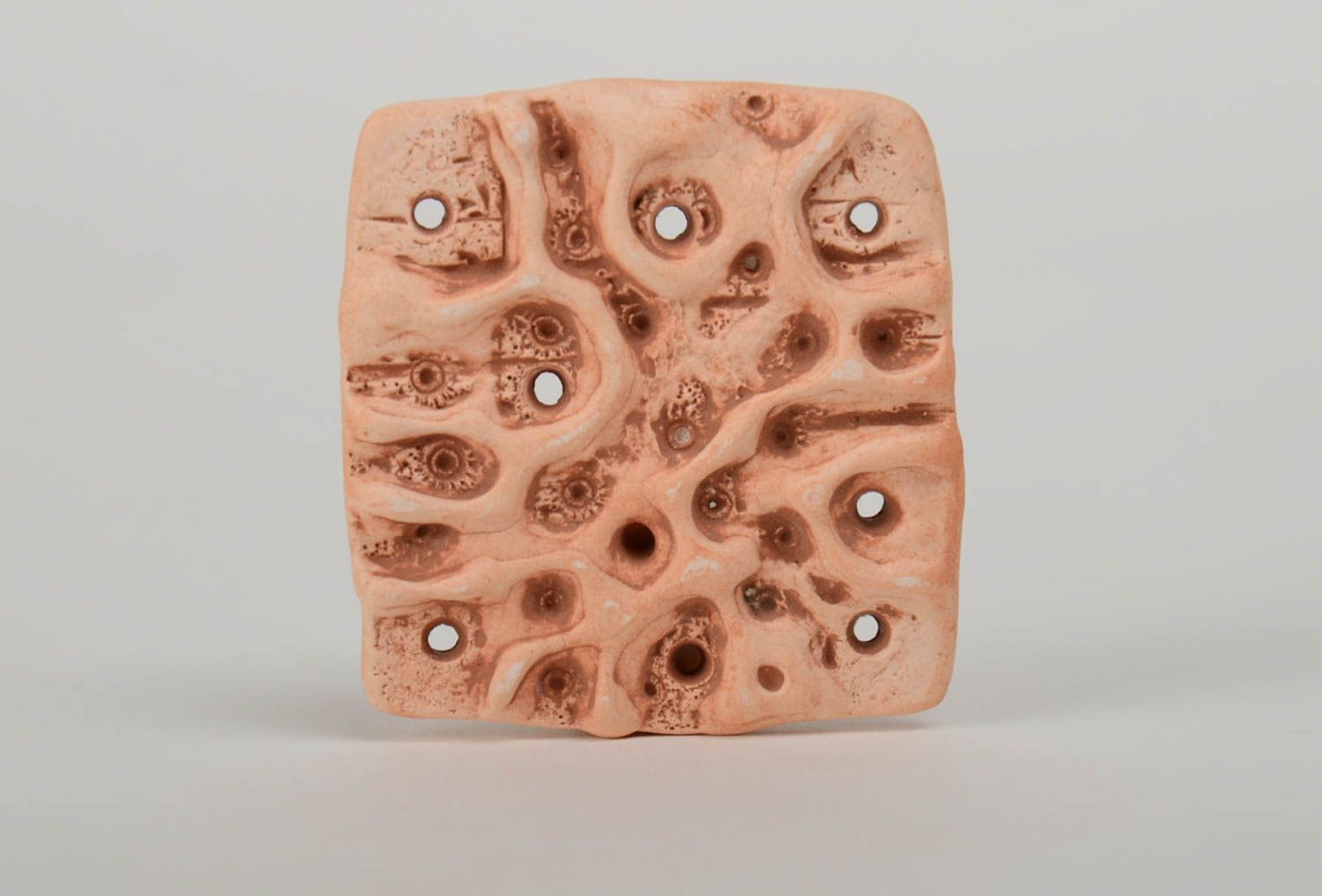 Handmade ceramic pendant of square shape molded of pottery clay with perforation photo 2