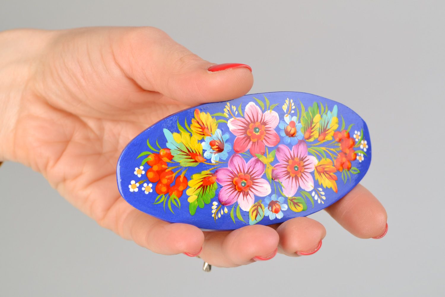 Handmade wooden oval hair clip with Petrikivka painting on blue background photo 2