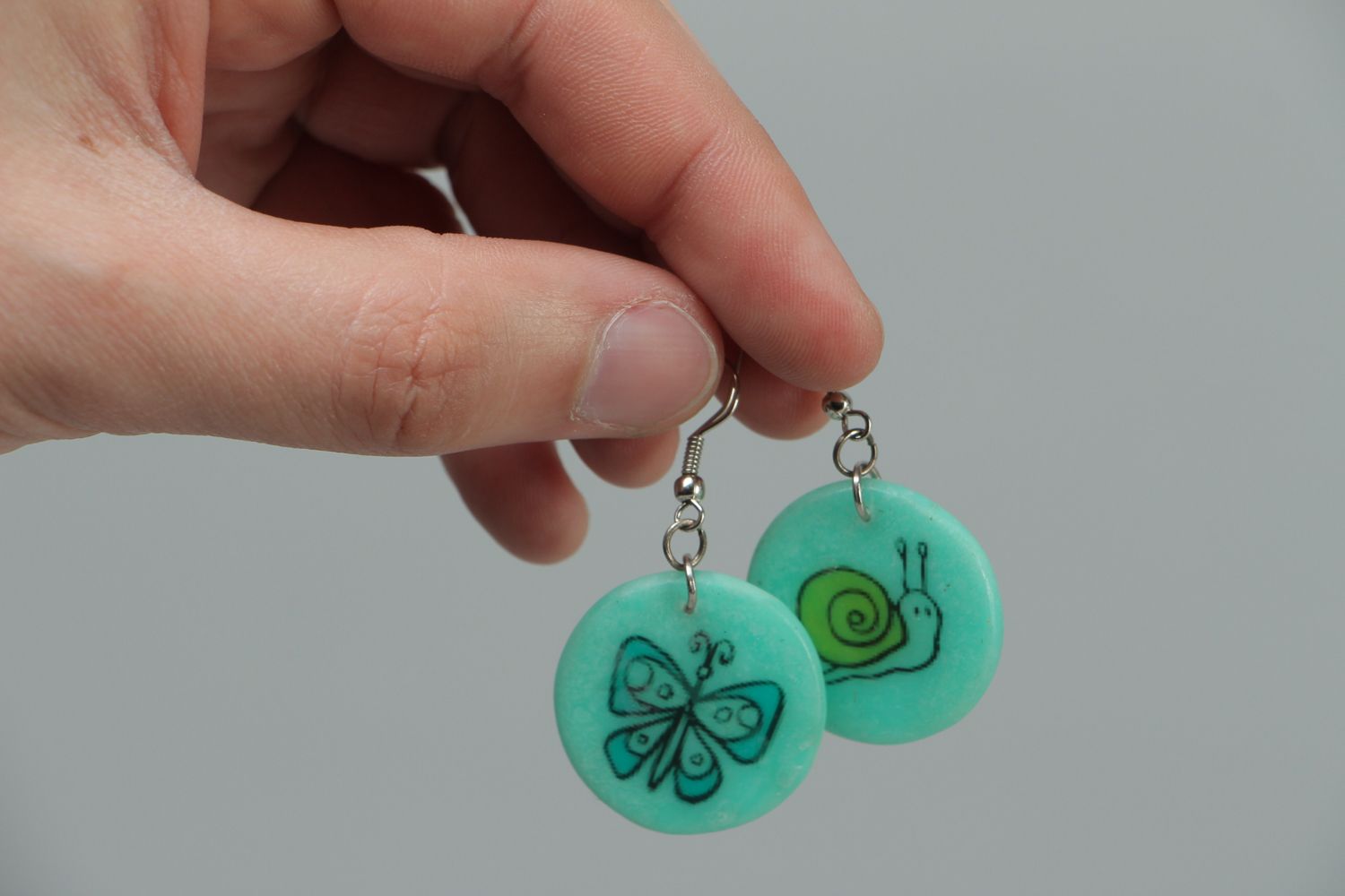 Turquoise plastic earrings with drawing photo 3