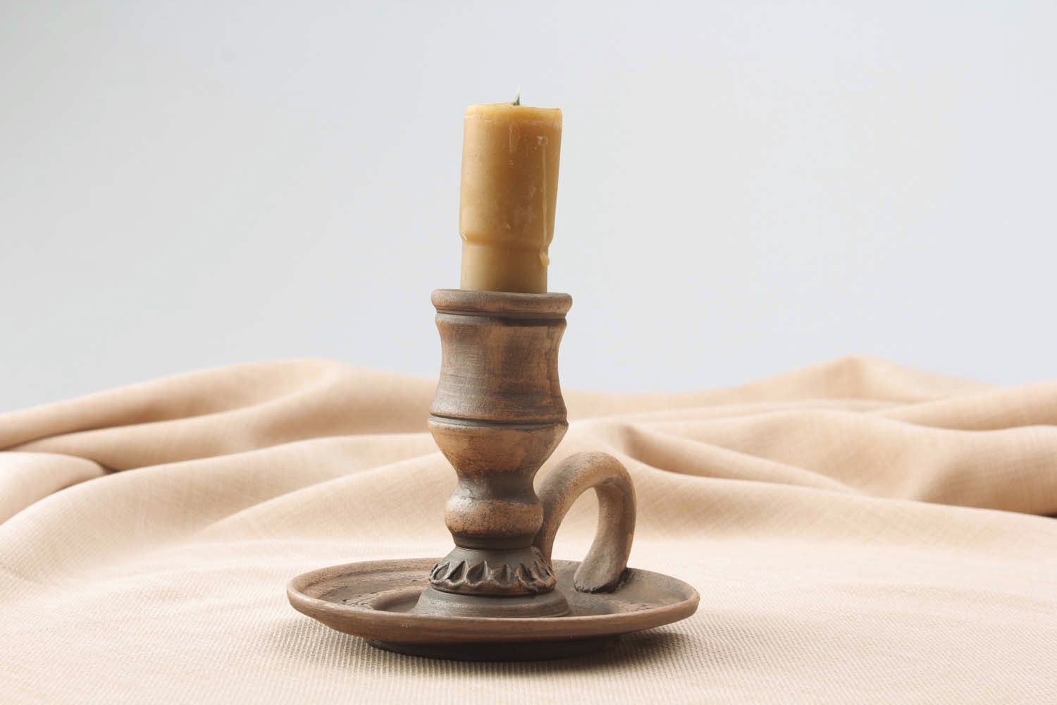 Candlestick made of red clay photo 1