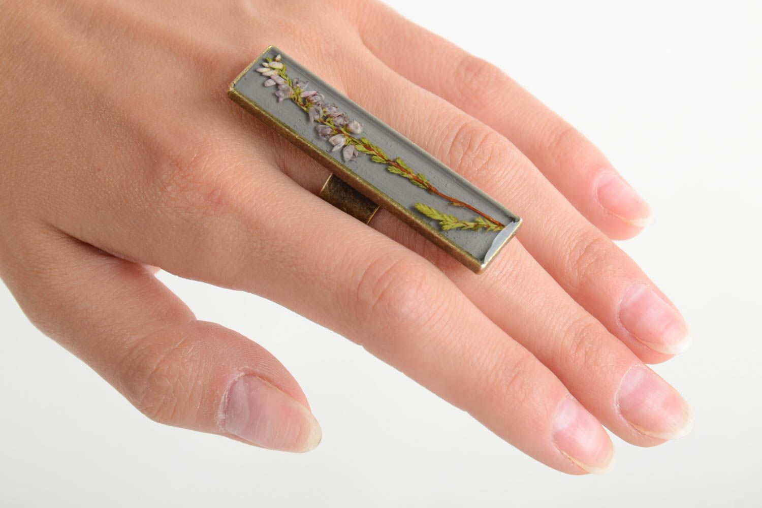 Beautiful designer women's ring with dried flowers coated with epoxy resin photo 2