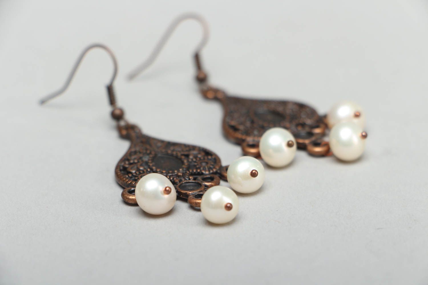 Metal earrings in Orient style with pearl-like beads photo 2