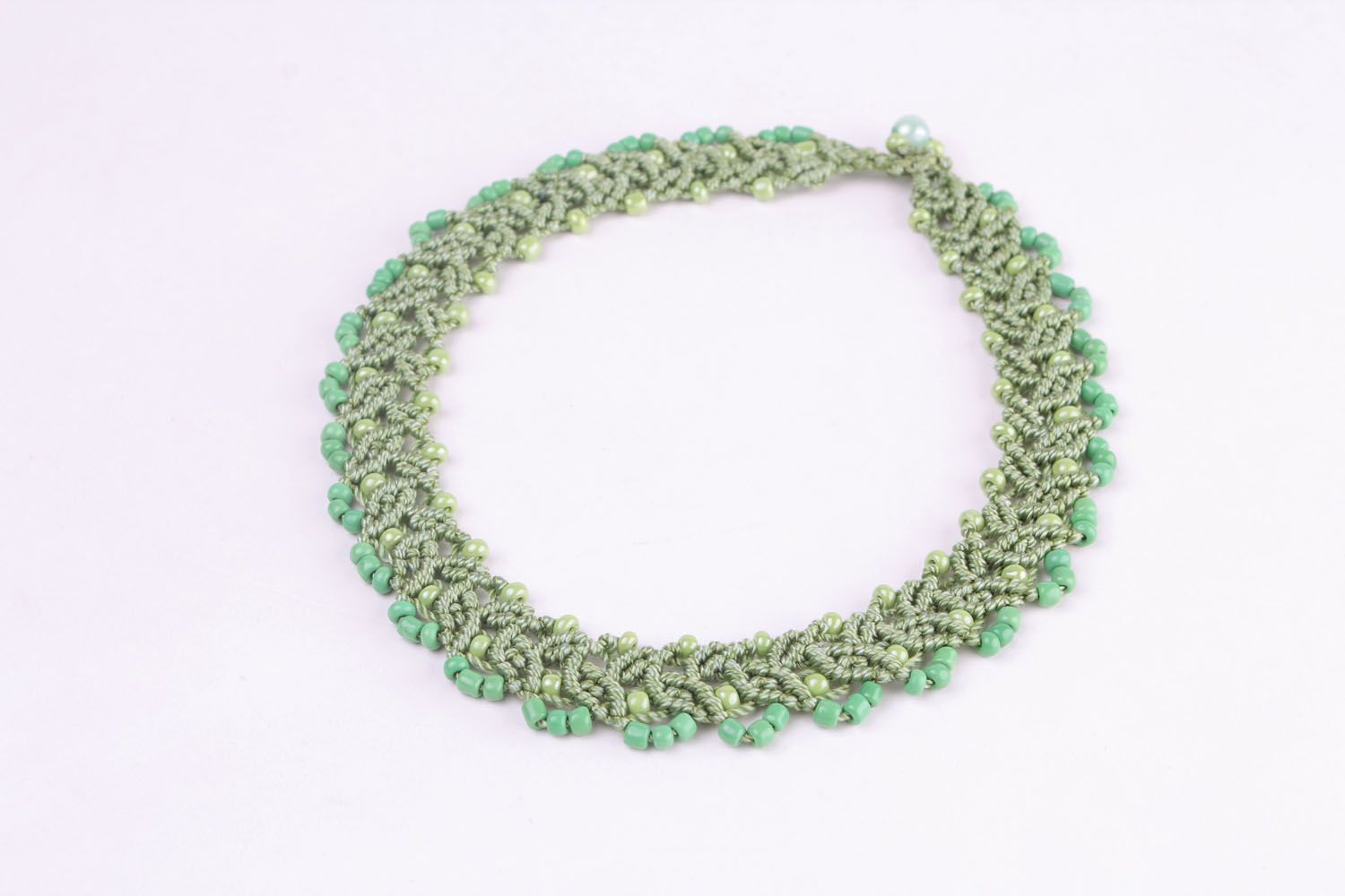 Green necklace made of threads and beads photo 4