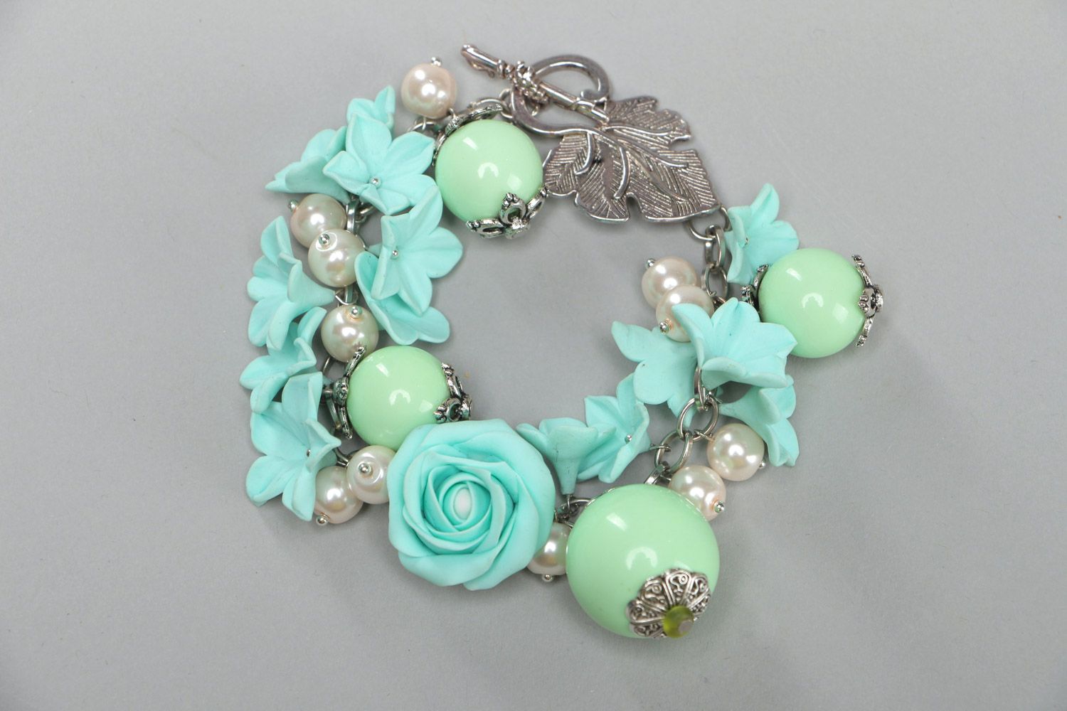 Handmade beautiful designer flower bracelet with charms made of polymer clay in mint color photo 1