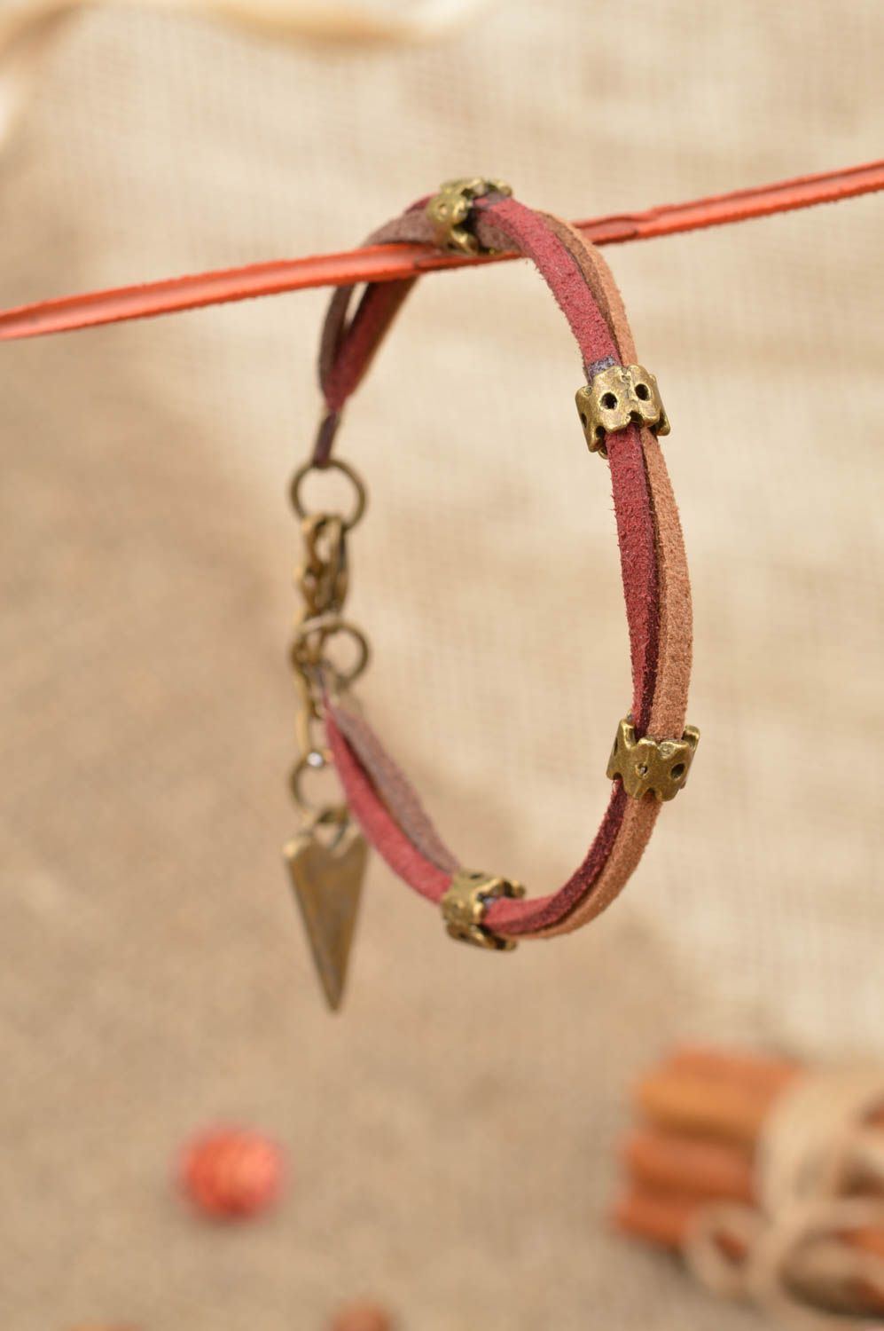 Handmade designer wrist suede cord women's bracelet with metal inserts and charm photo 1