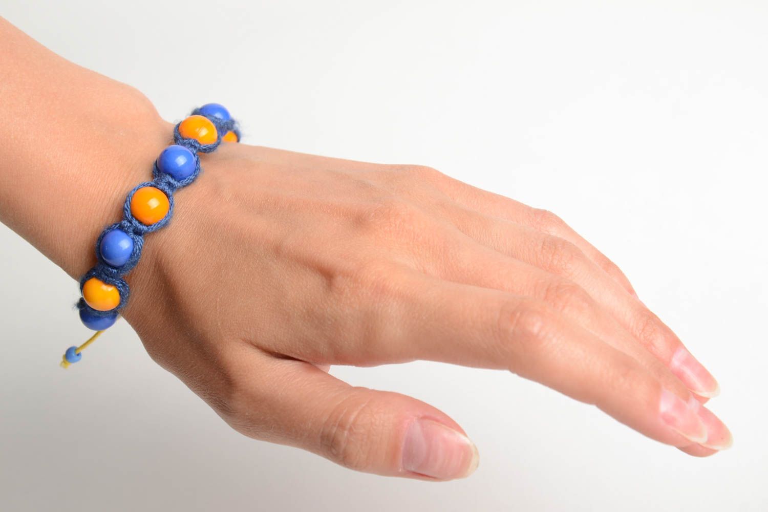 Handmade friendship bracelet woven of blue cord and orange beads for children photo 2