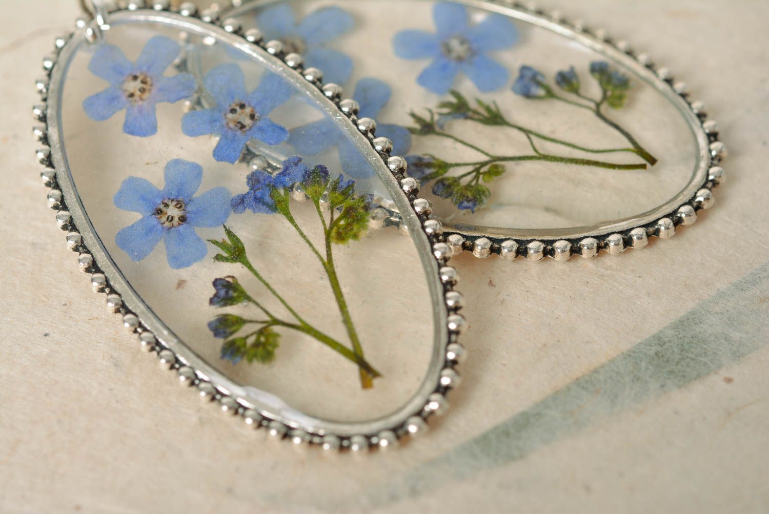 Handmade oval transparent dangle earrings with blue dried flowers in epoxy resin photo 3