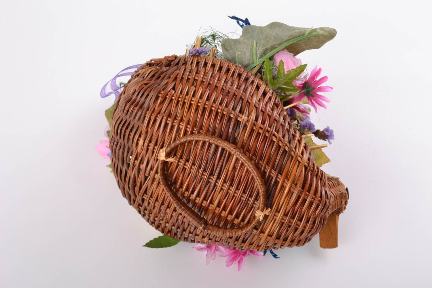 Handmade ikebana made of artificial flowers in wicker basket in the form of duck photo 4