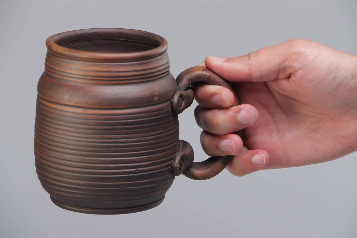 Handmade decorative dark brown ceramic beer mug kilned with milk in ethnic style photo 5