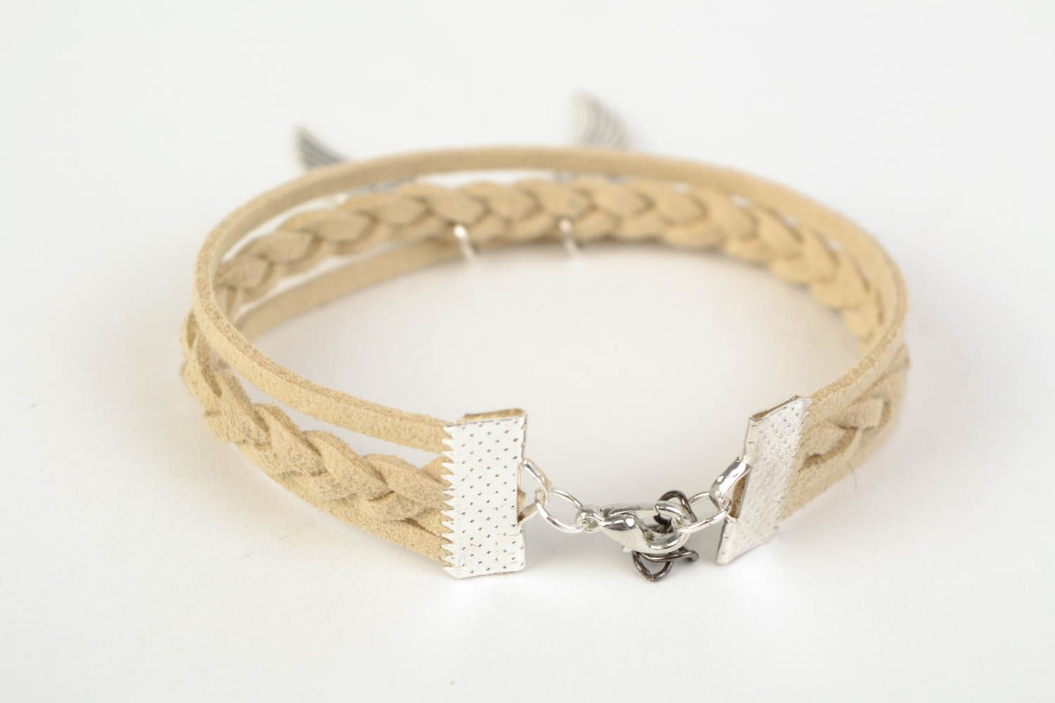 Beige handmade woven suede cord bracelet with charm in the shape of wings photo 4