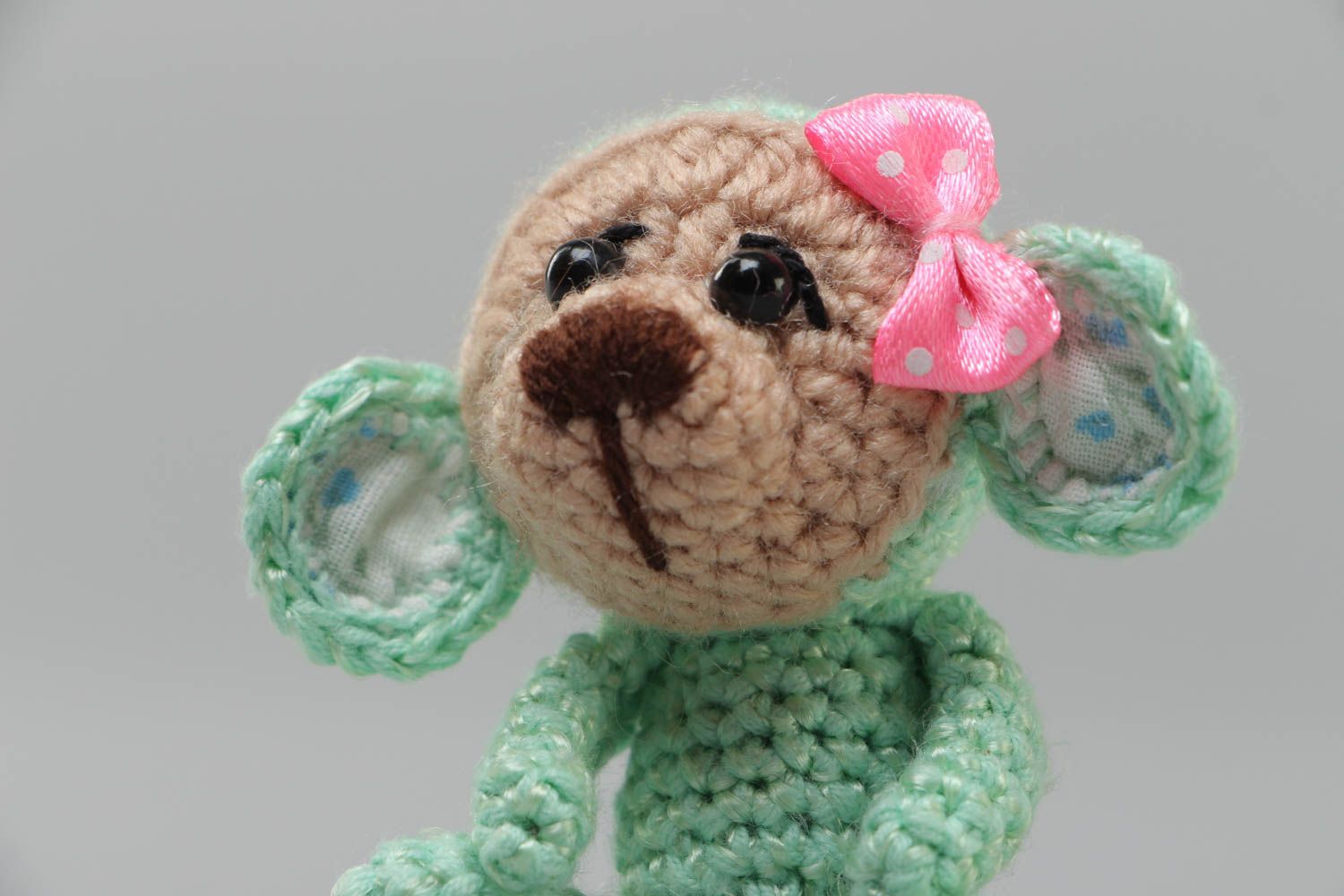 Handmade small funny soft toy crocheted of acrylic threads Green Monkey with bow photo 3