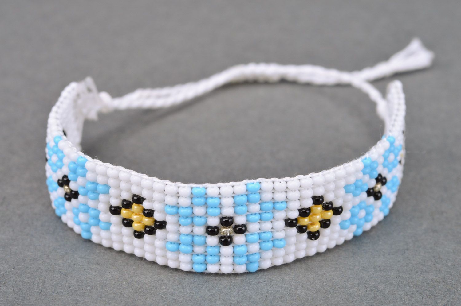 Broad handmade wrist bracelet with ethnic ornament in white and blue colors photo 2