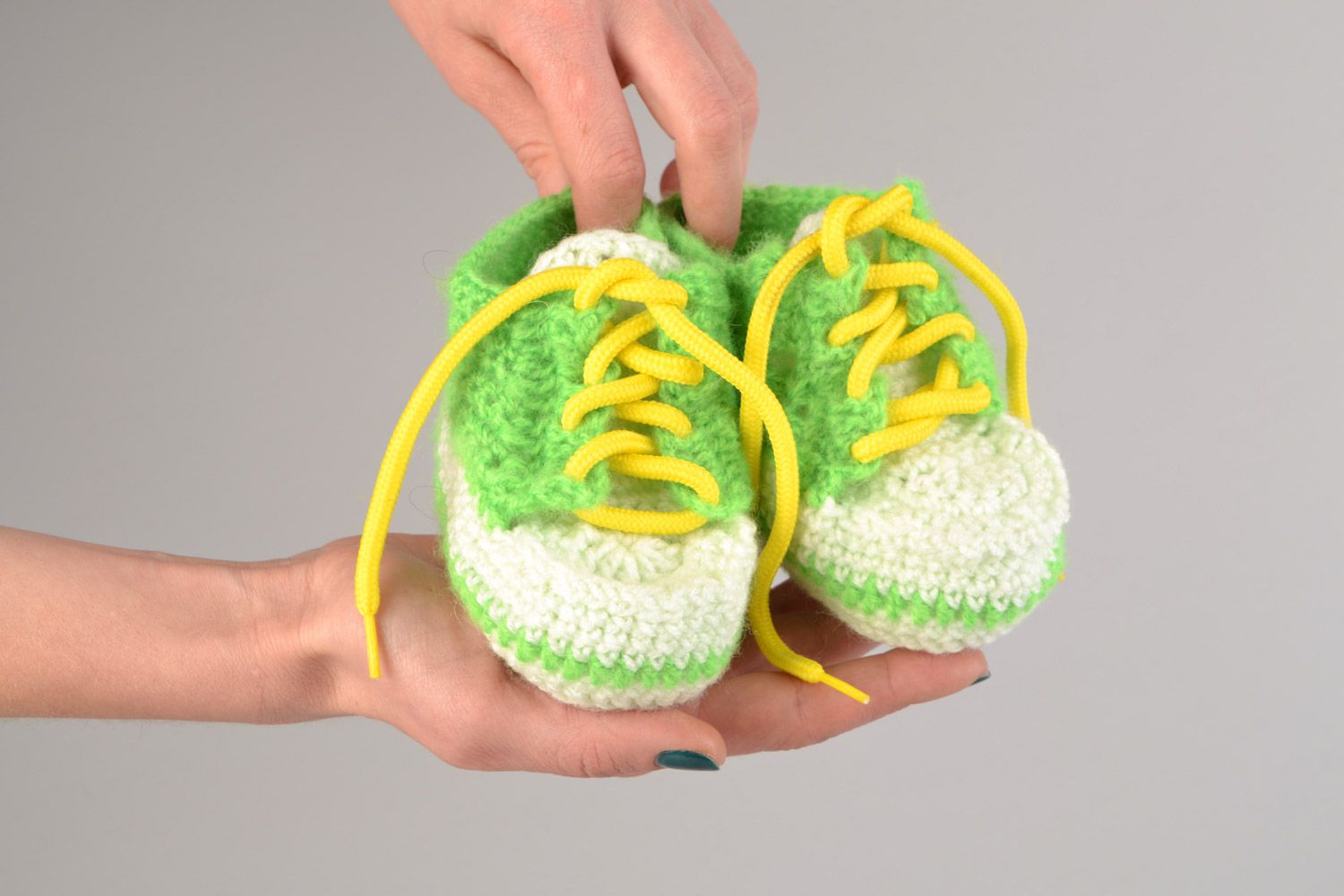 Handgemachte Babyschuhe gehäkelt aus Acrylfäden in Grün und Weiß mit Schnürsenkel  foto 2