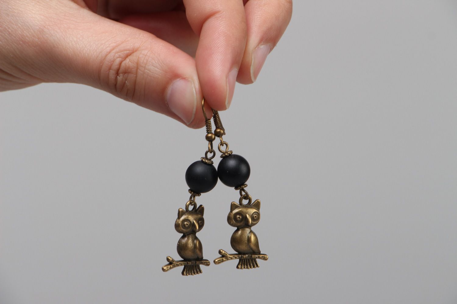 Handmade dangle earrings with shungite beads and metal charms in the shape of owls photo 3