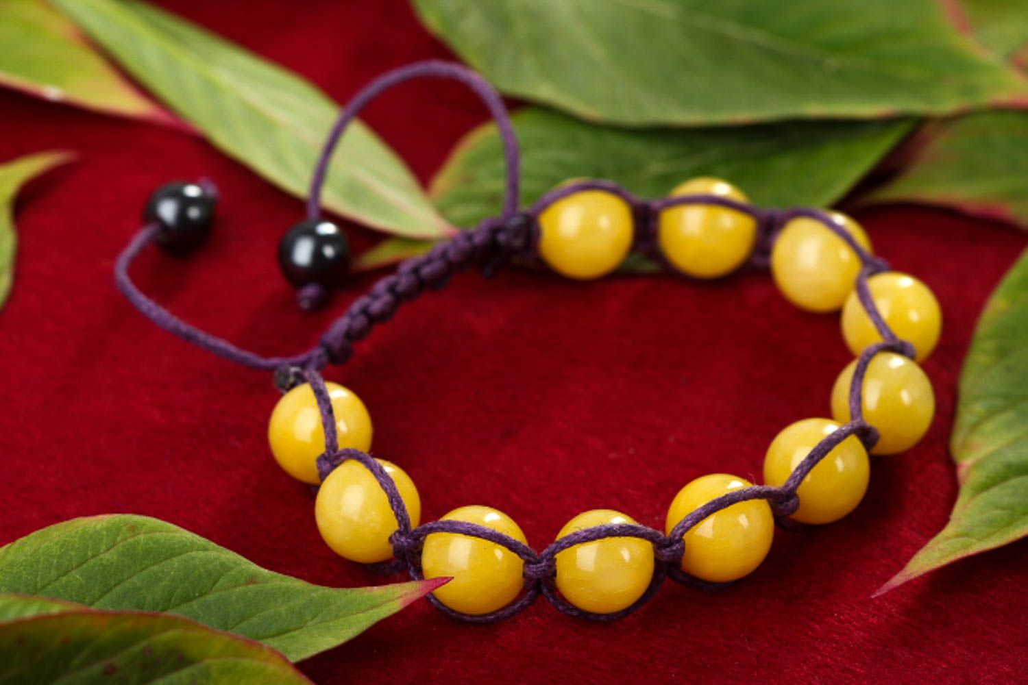 Yellow hematite and calcite beads strand bracelet on black cord  photo 1