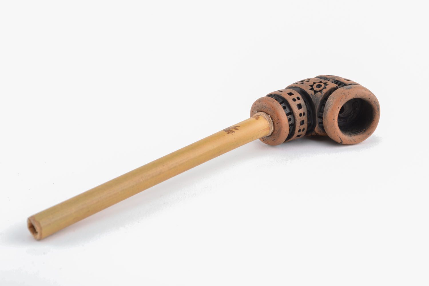 Clay smoking pipe in ethnic style photo 1