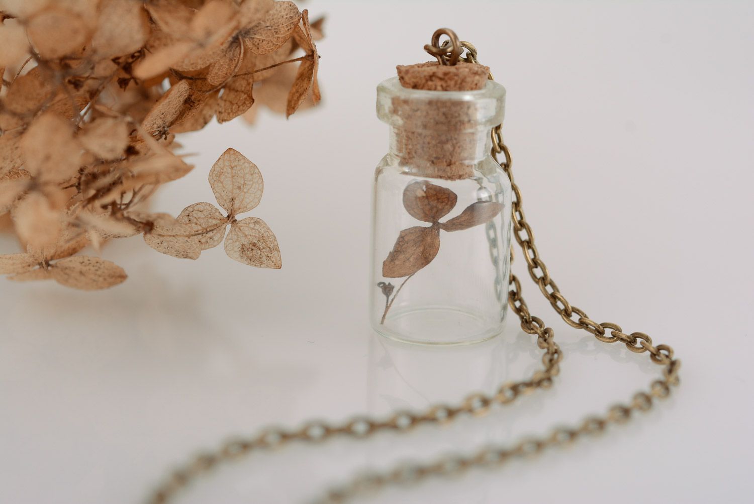 Small handmade glass vial with cork pendant with plant inside on metal chain photo 1