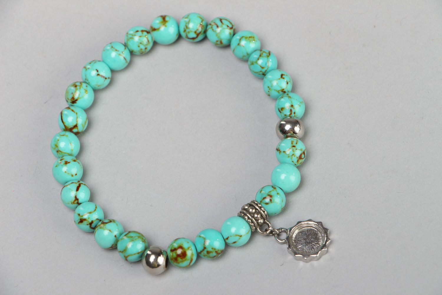 Handmade stretch wrist bracelet with natural turquoise beads and metal charm photo 2