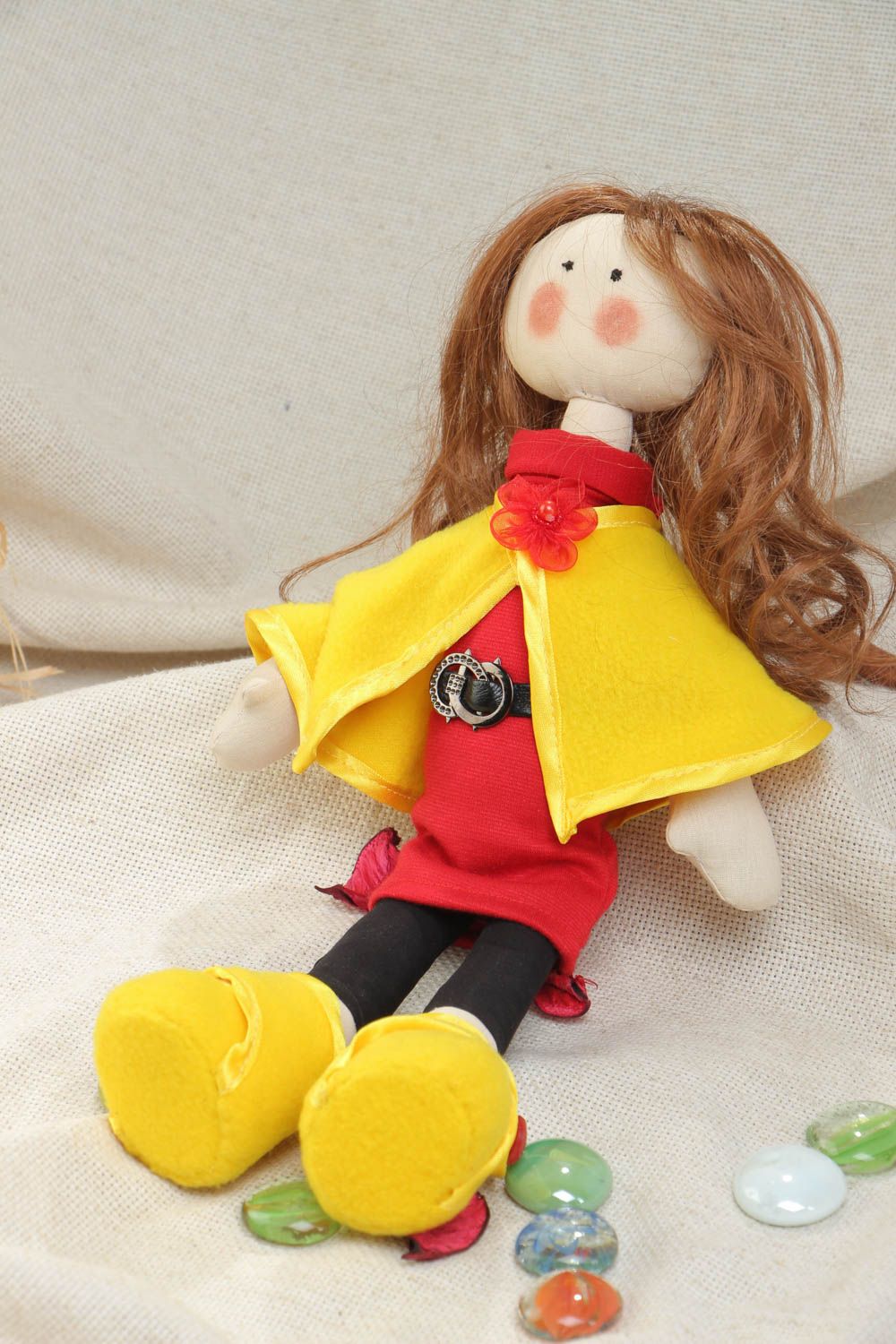Handmade soft doll sewn of cotton fabric in yellow coat and shoes for children photo 1