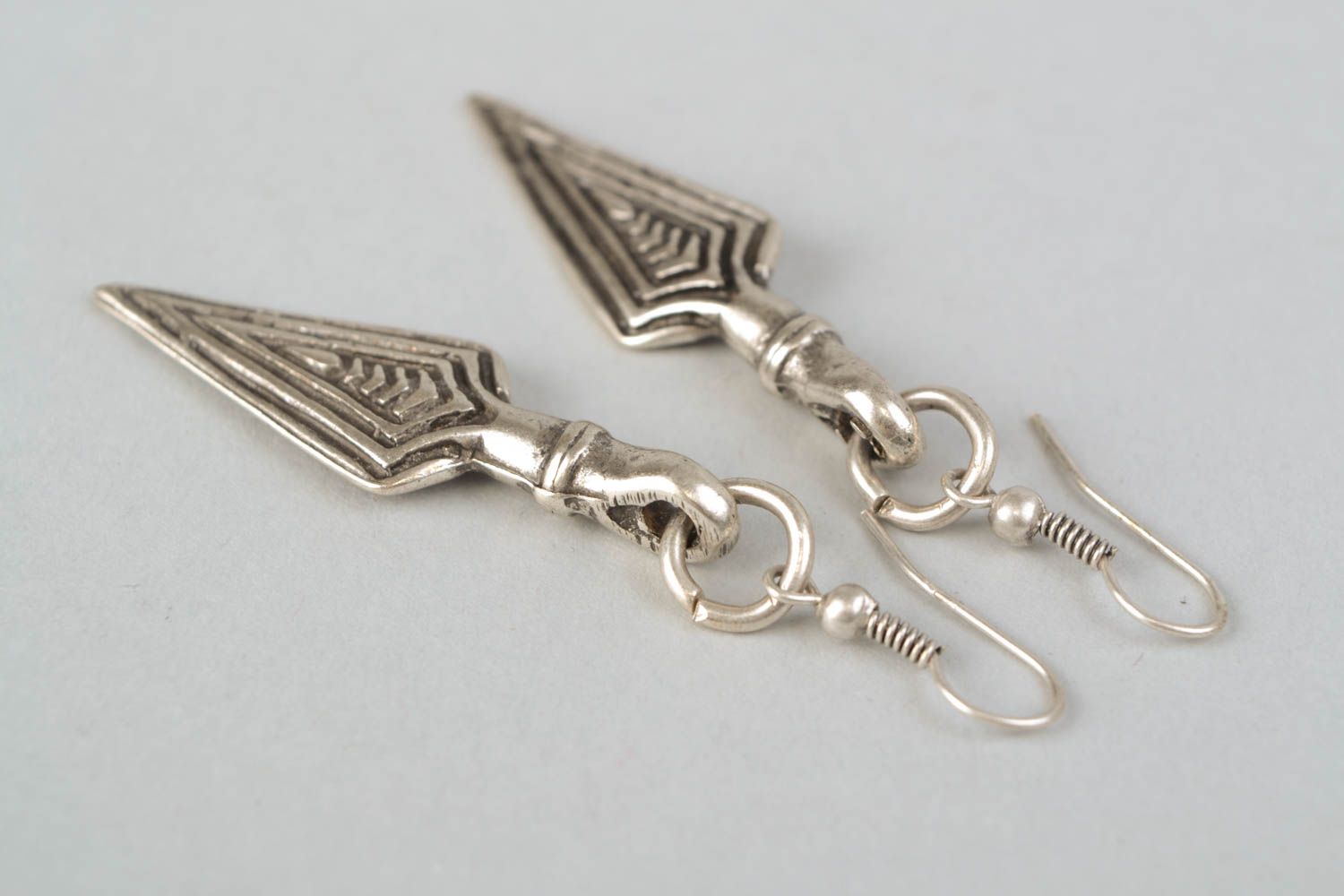Metal earrings with charms in the shape of pikes photo 4