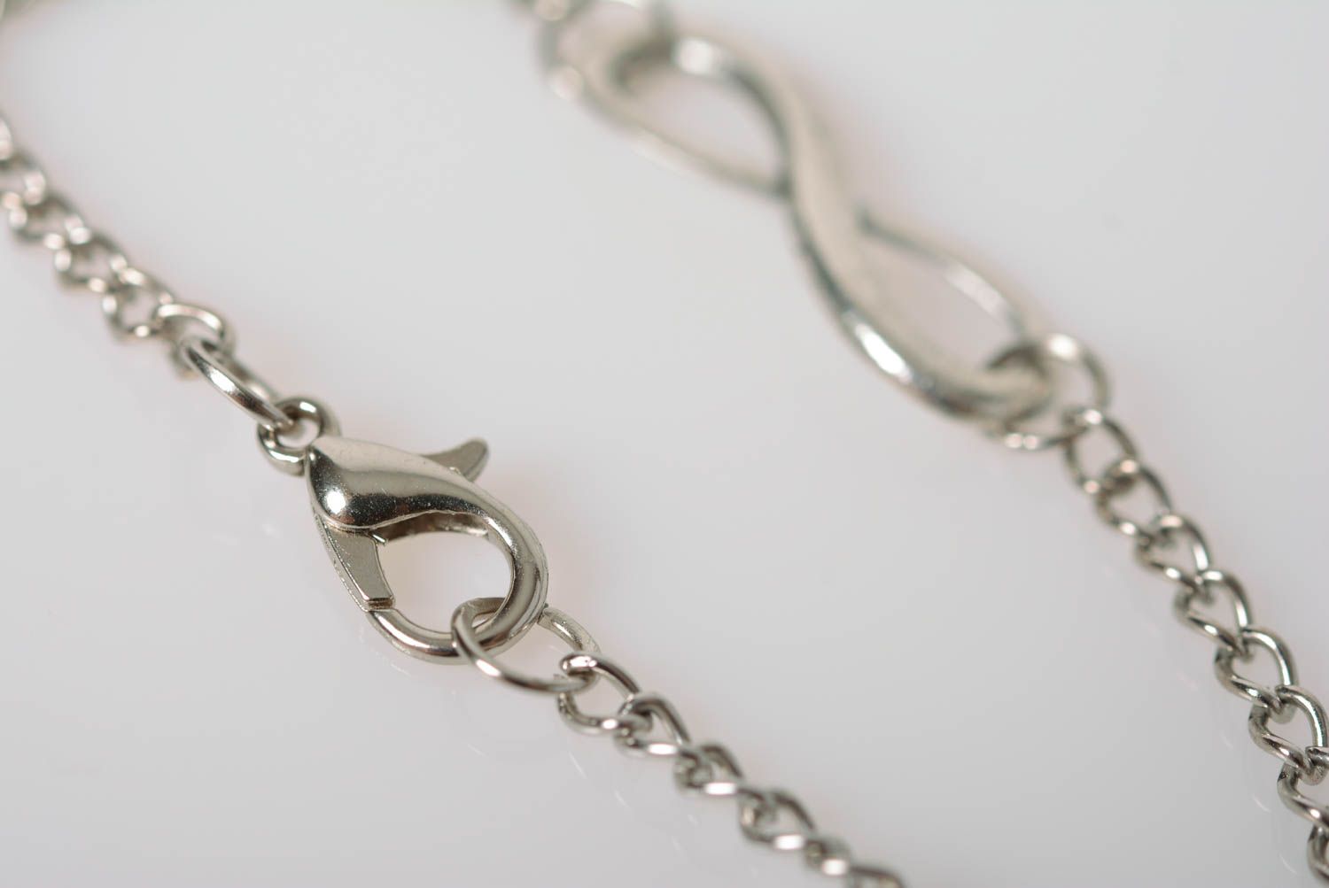 Handmade designer wrist bracelet with metal chain and infinity shaped insert photo 5