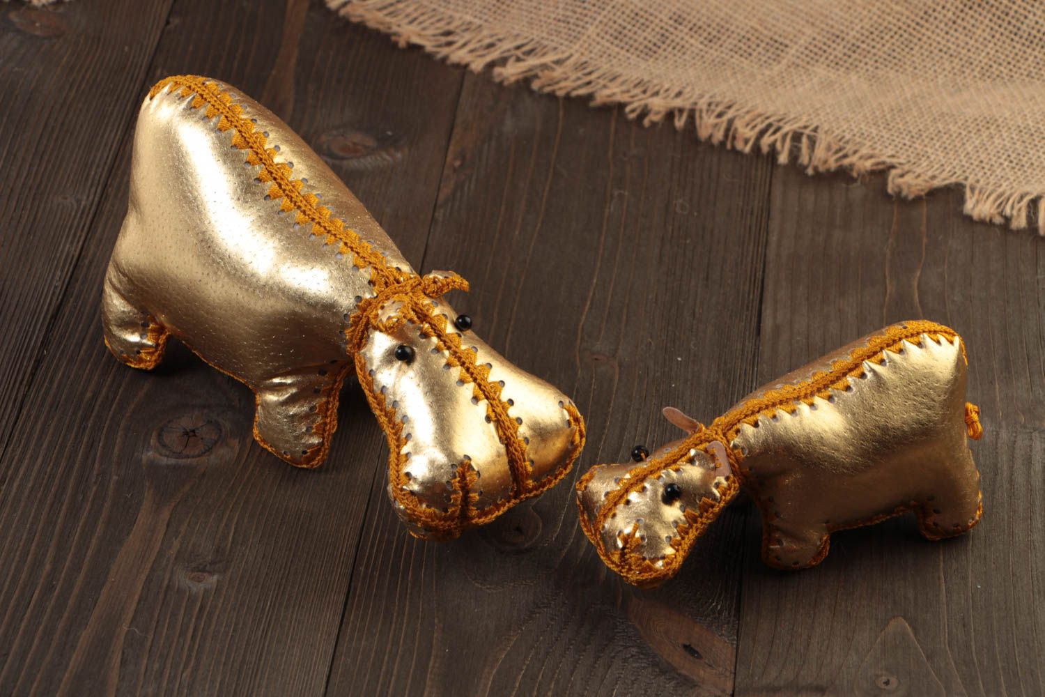 Set of 2 handmade designer soft toys hippos sewn of leather of golden color photo 1