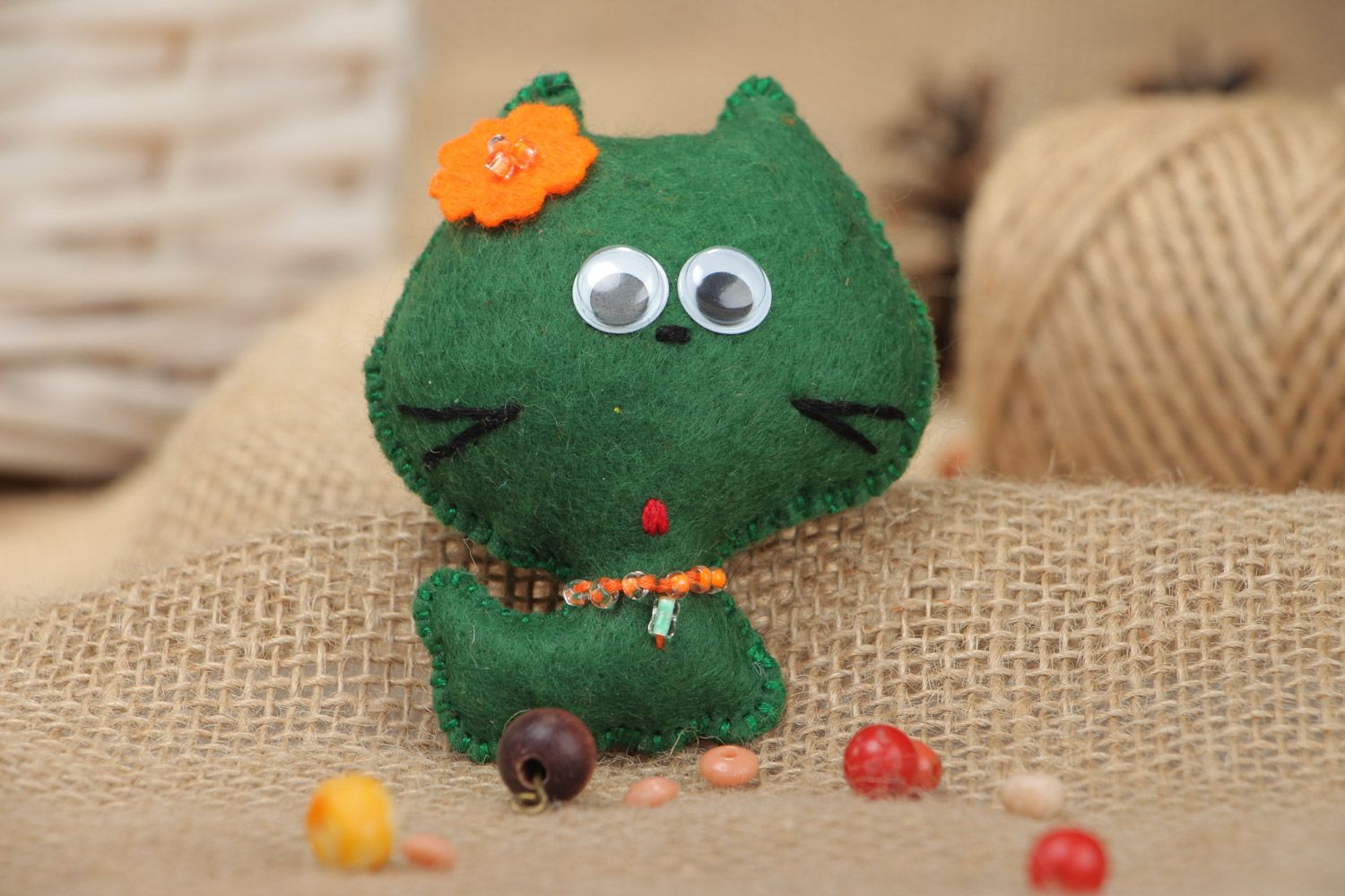 Small cute homemade soft toy sewn of green felt little kitten with orange flower photo 1