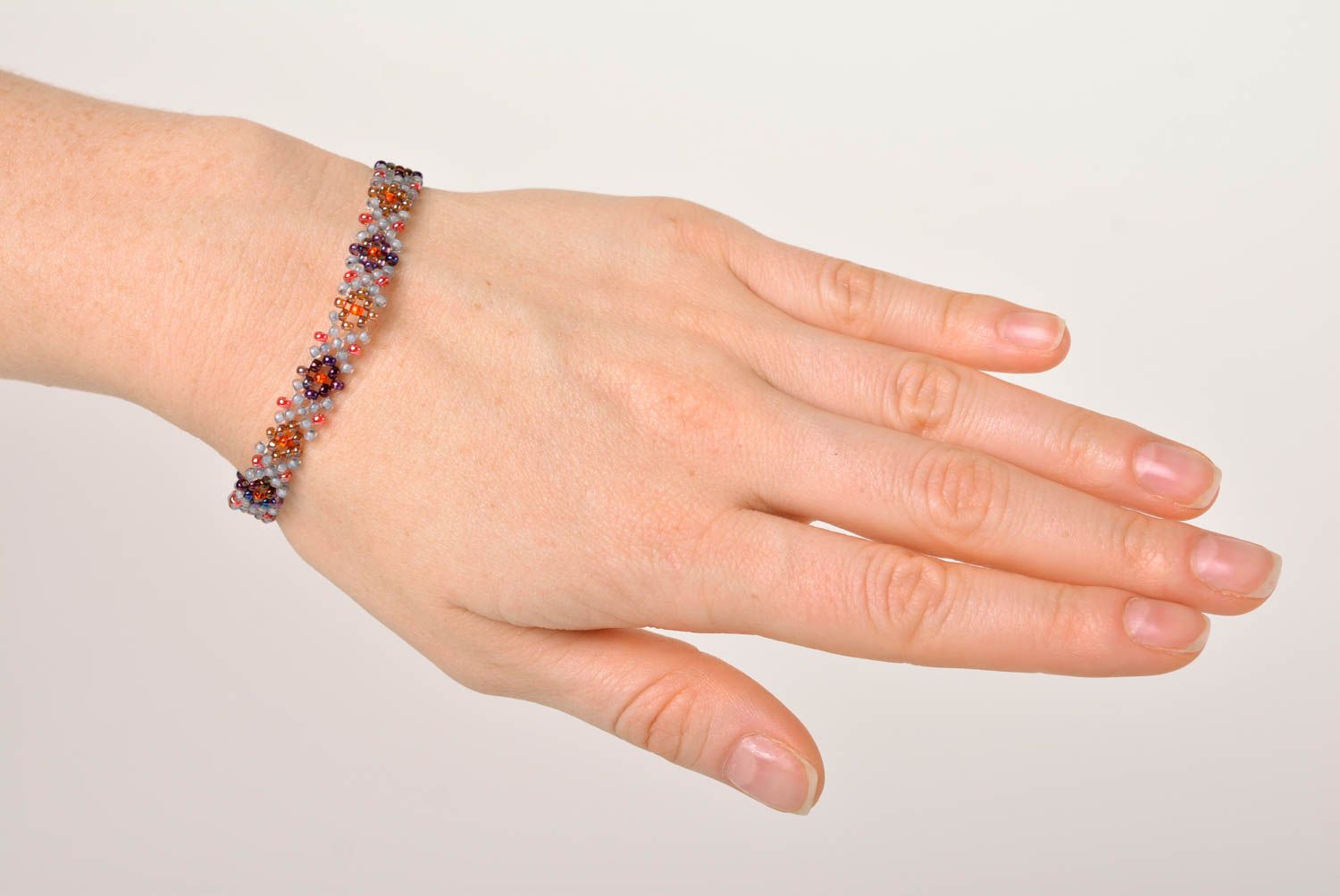 Light handmade narrow beaded wrist bracelet in red and gray colors  photo 2